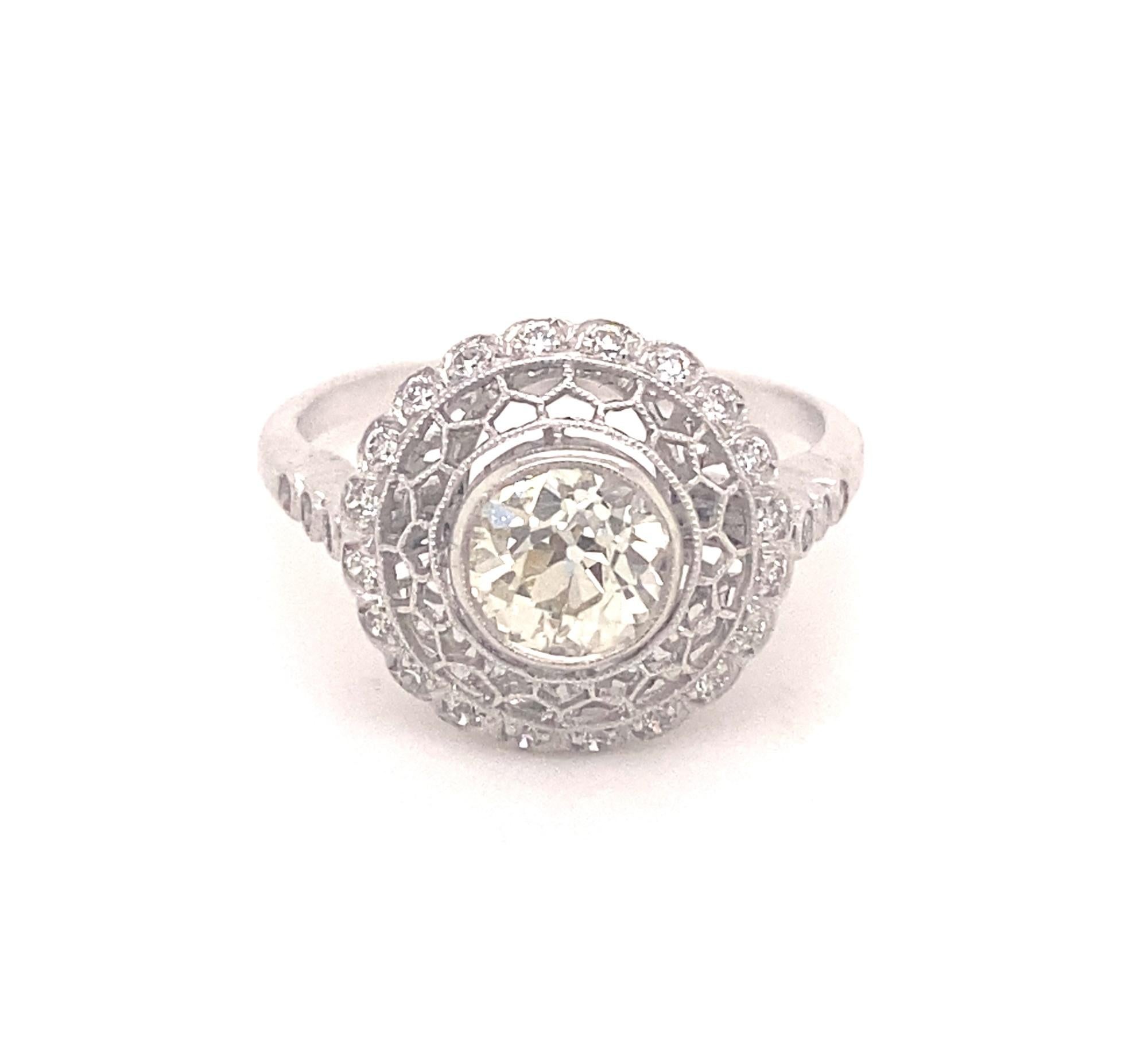 This is a beautiful vintage filigree .87 carat diamond engagement set in platinum. The center diamond is J color VS-2 clarity eye clean bright and fiery.  Around the center diamond is a halo of 20 diamonds I color VS-2 clarity. On each shoulder of
