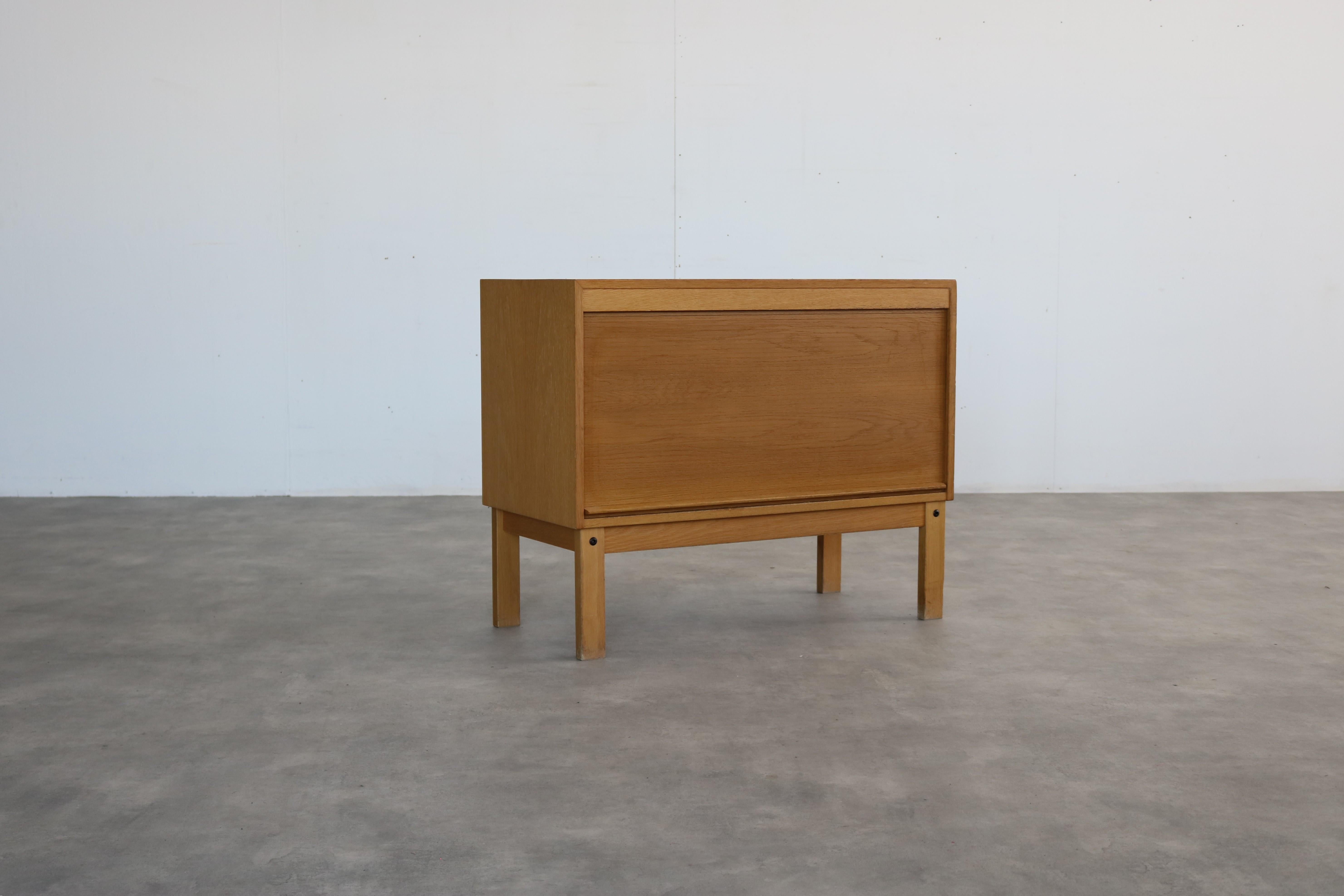 vintage filing cabinet  sideboard  1960s  Swedish

period  1960s
design  unknown  Sweden
condition  good  light signs of use  veneer side leg; 
size  68 x 85 x 40 (hxbxd)

details  tambour door; oak;

item number  2833