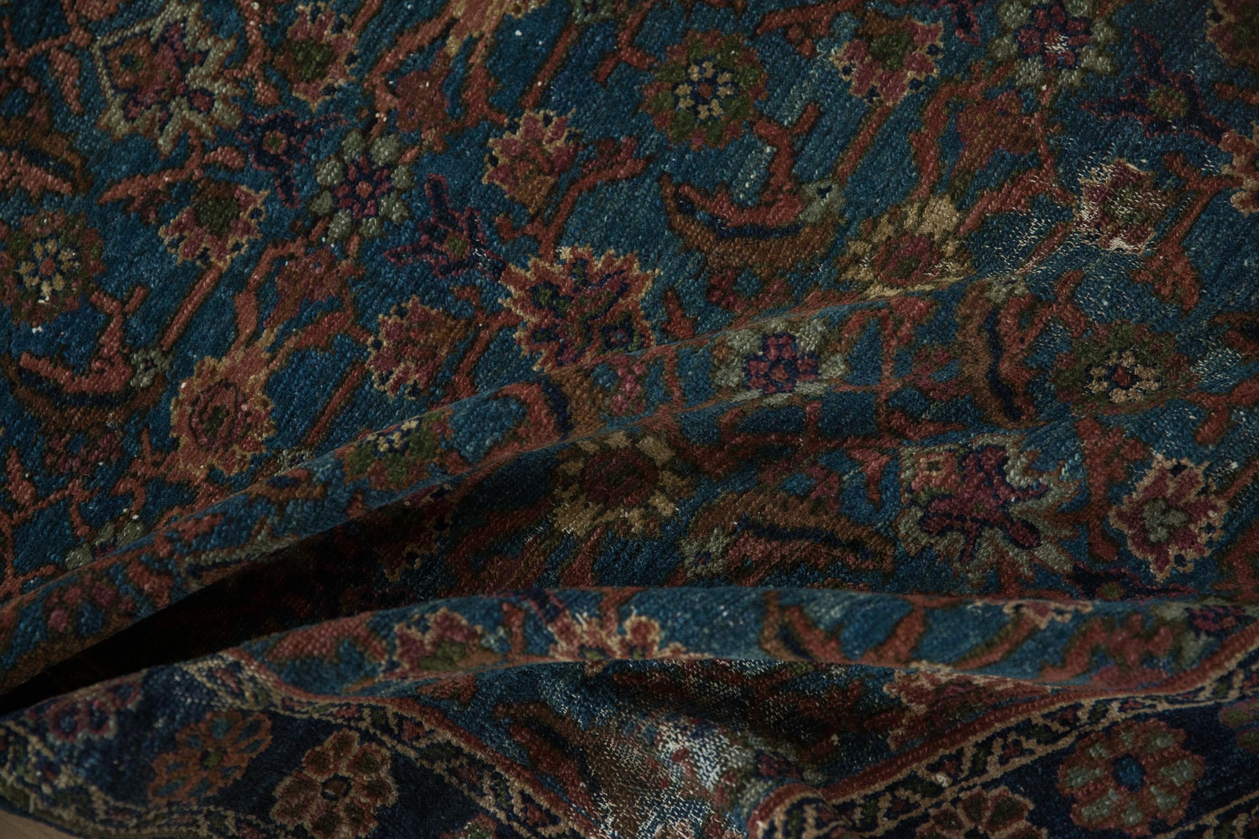 :: Allover covered field in a Herati design motif atop an abrashed ground with vivid gem-like shades. Colors and shades include: Sky blue, sapphire blue, navy blue, pale terracotta, coffee brown, copper, and more. Condition notes: Mostly even wear
