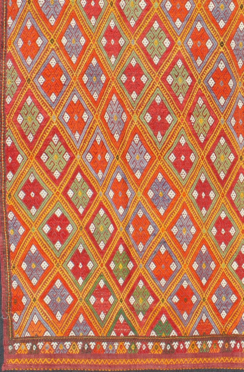 Measures: 5'6'' x 9'0''.
Featuring tribal diamond shapes with a spotted and speckled assortment of geometric elements, this finely woven embroidered Jijim showcases an array of rich colorful tones. Colors include blue, gray, red, orange, brown,