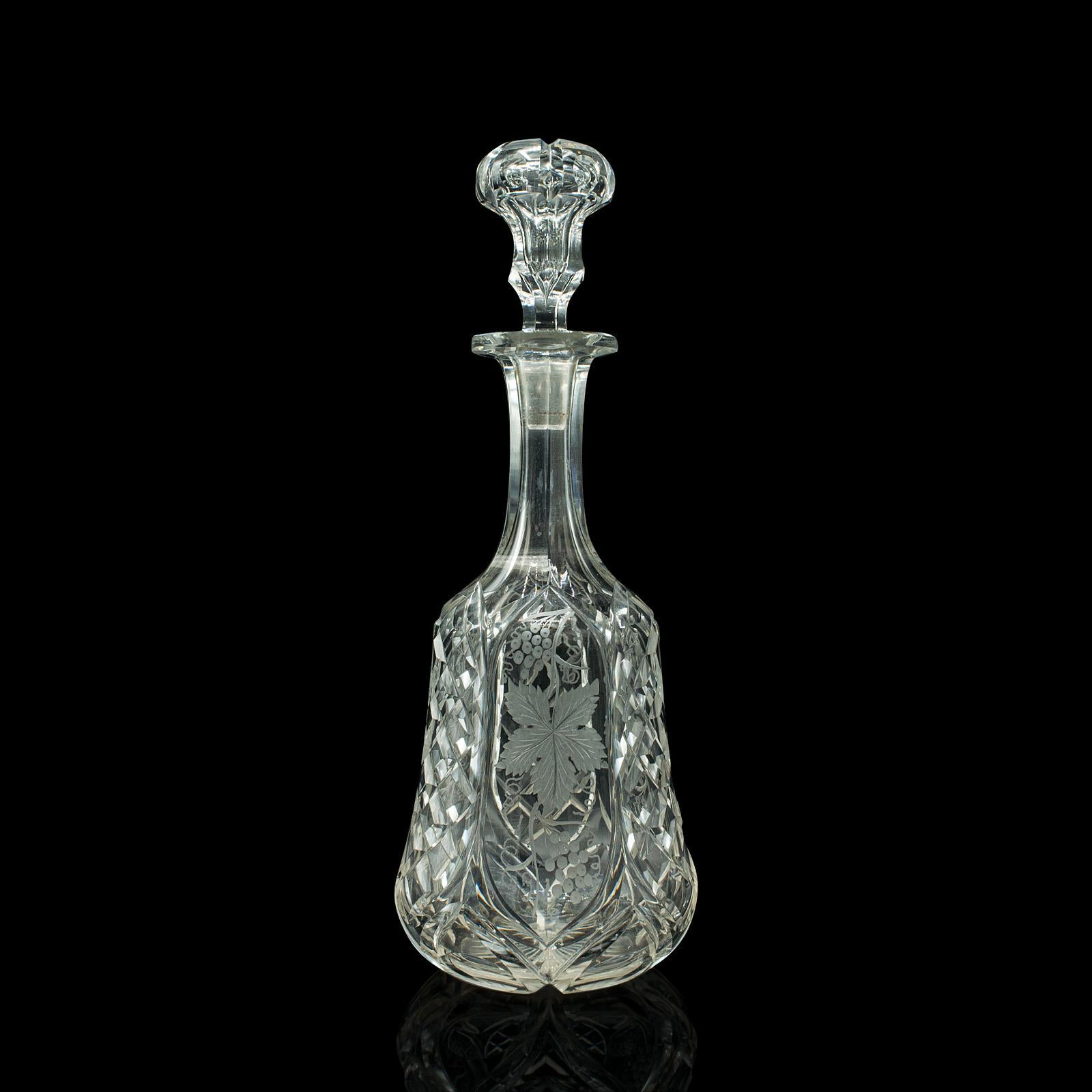 This is a vintage fine wine decanter. An English, etched glass spirit vessel, dating to the mid 20th century, circa 1950.

Beautifully cut and etched, ideal for the living room or club lounge
Displays a desirable aged patina and in good