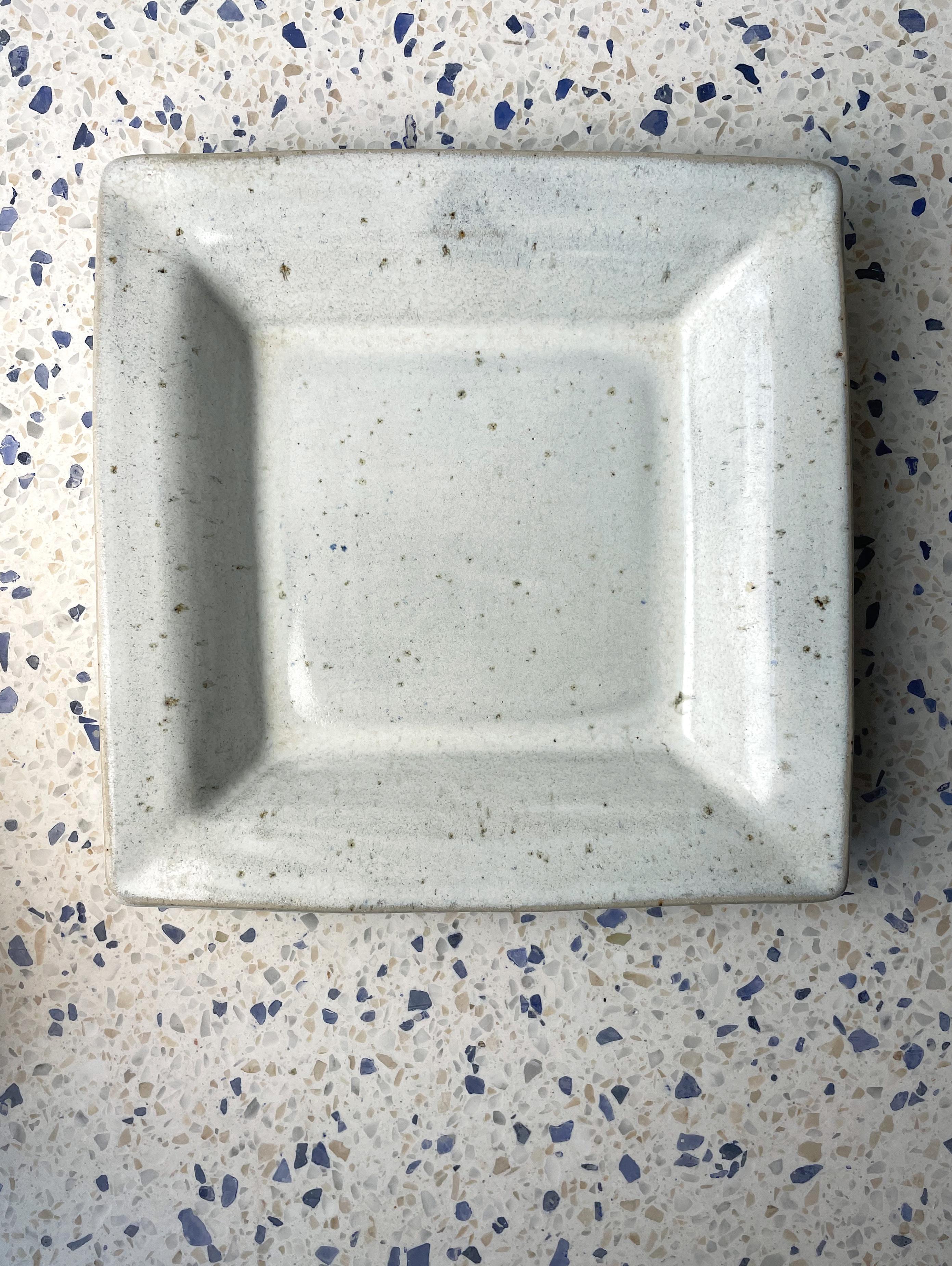 Beautiful simplistic midcentury modernist piece from the 1970s by Danish artist Finn Lynggaard (1930-2011). Soft square shaped bowl / plate / centerpiece with rounded corners. Light gray glaze with a light pastel blue tint. Signed and stamped under