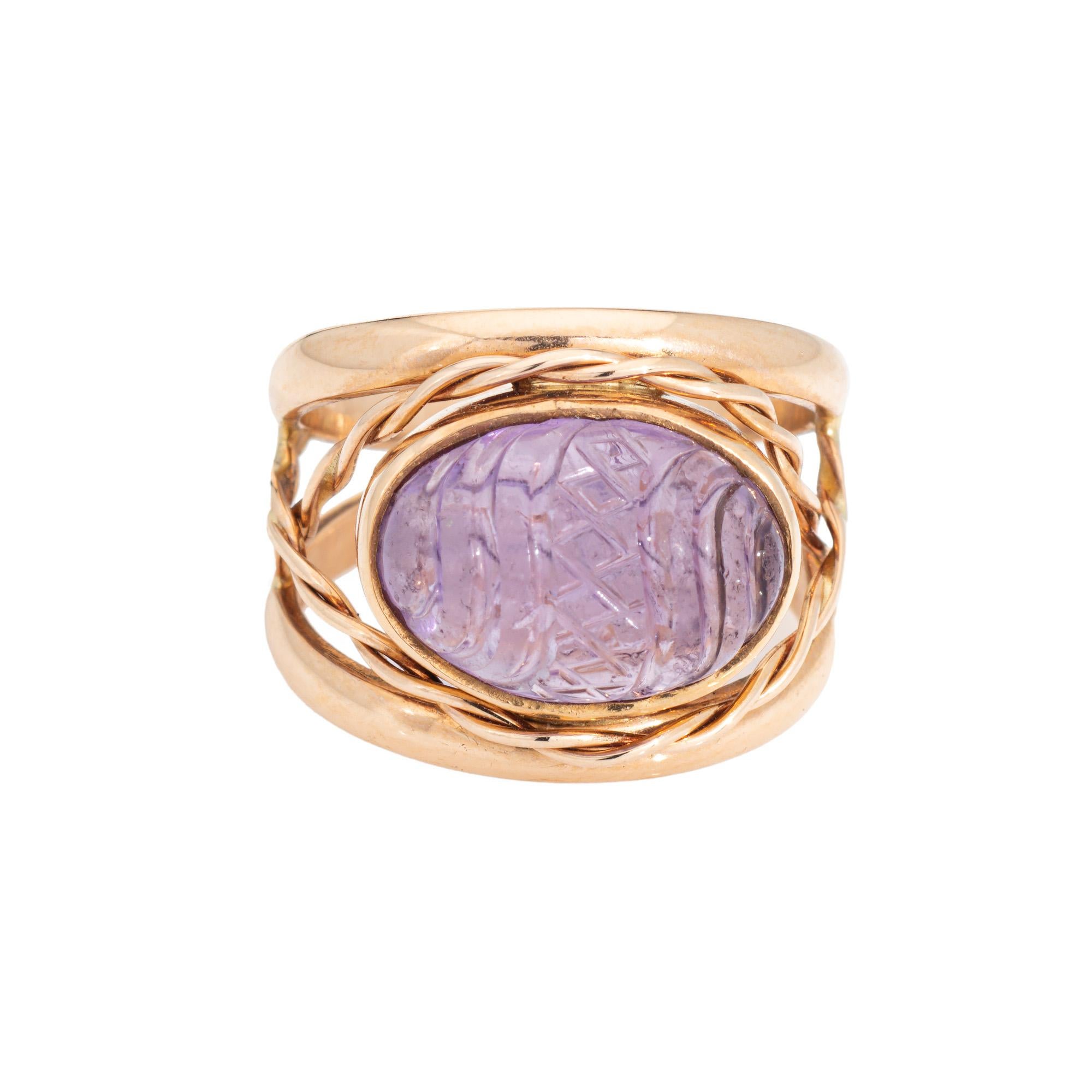Stylish vintage carved amethyst cocktail ring crafted in 14 karat yellow gold. 

Carved amethyst measures 13.5mm x 9mm (note: light surface abrasions to the amethyst). 

The amethyst is carved with a scrolled design and diamond pattern to the