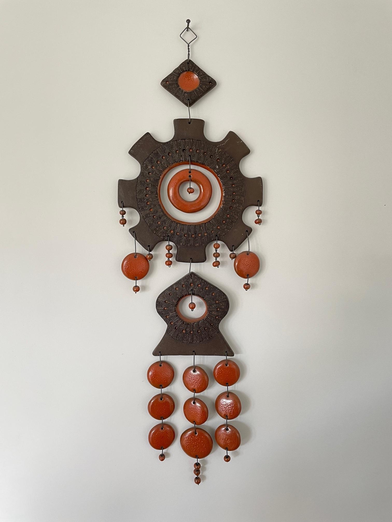 Gorgeous Kalevala Koru pieced pottery wall hanging from Finland, designed by Maija-Liisa Vasenius and collected in the 1960s. Great orange and brown colors. You see the artistic and beautiful handwork. The multiple ceramic elements are connected