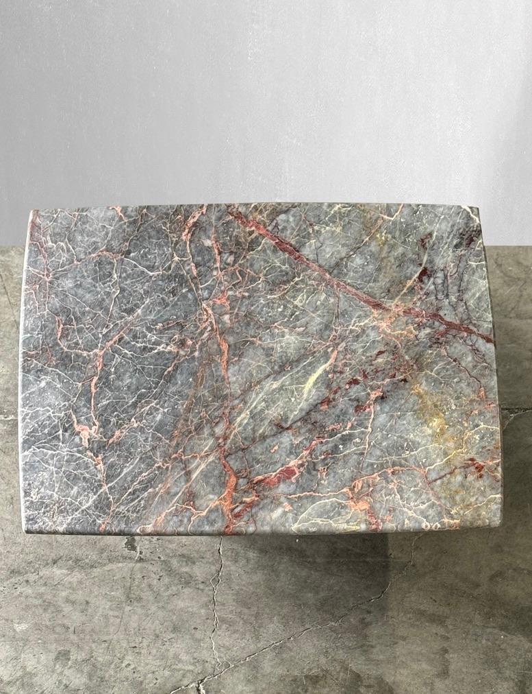 This coffee table boasts a beautiful Italian Fior di Pesco marble top with hues of grays and rusts. The top of this table has some of the most beautiful movement and colors we’ve seen yet!

Thin top sits on a matching base and make this table unique