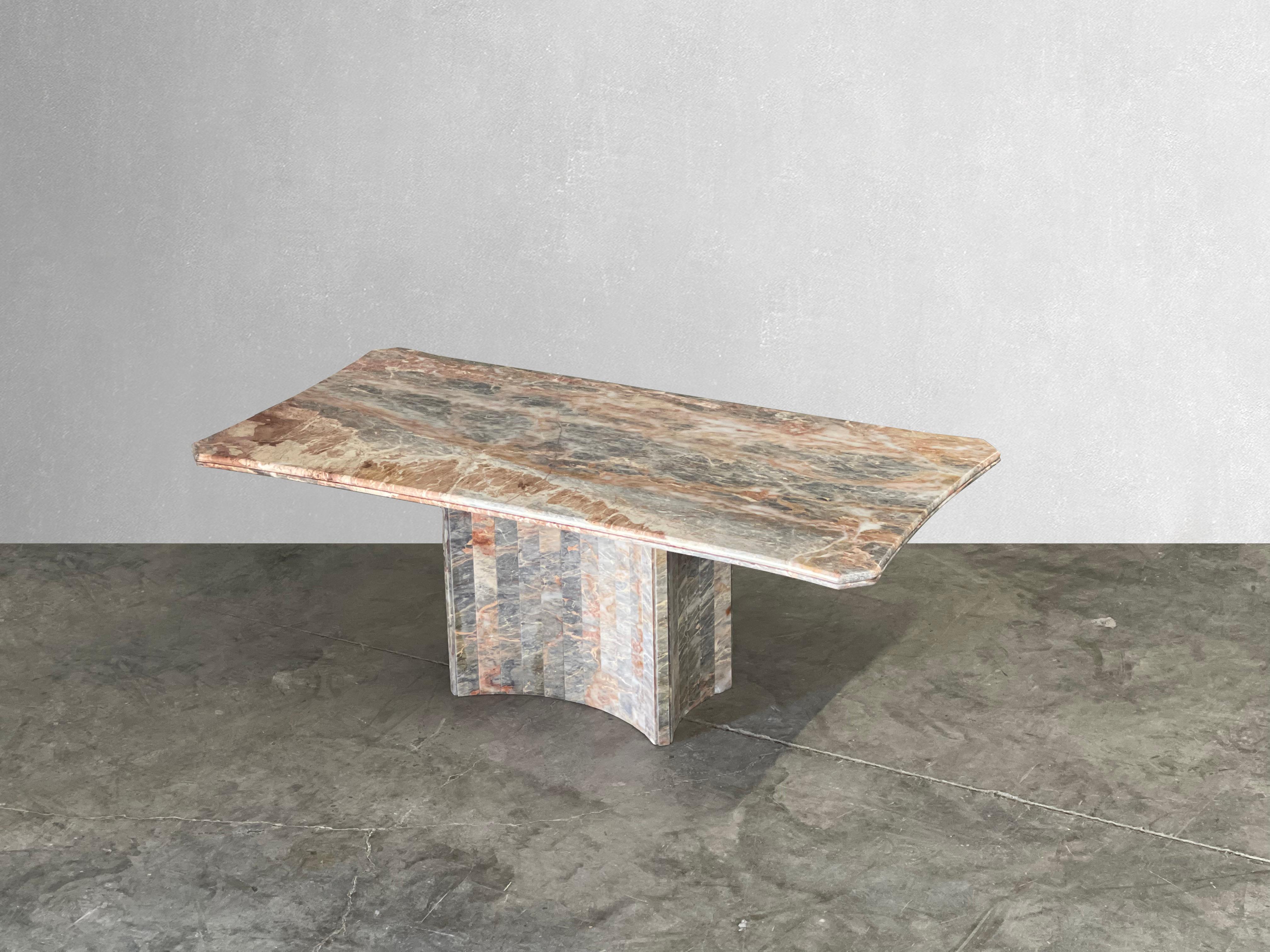 This dining table boasts a beautiful Italian Fior di Pesco marble top with hues of grays and rusts. The base is curved with a slatted detail. The top of this table has some of the most beautiful movement and colors we've seen yet!

Angled corners