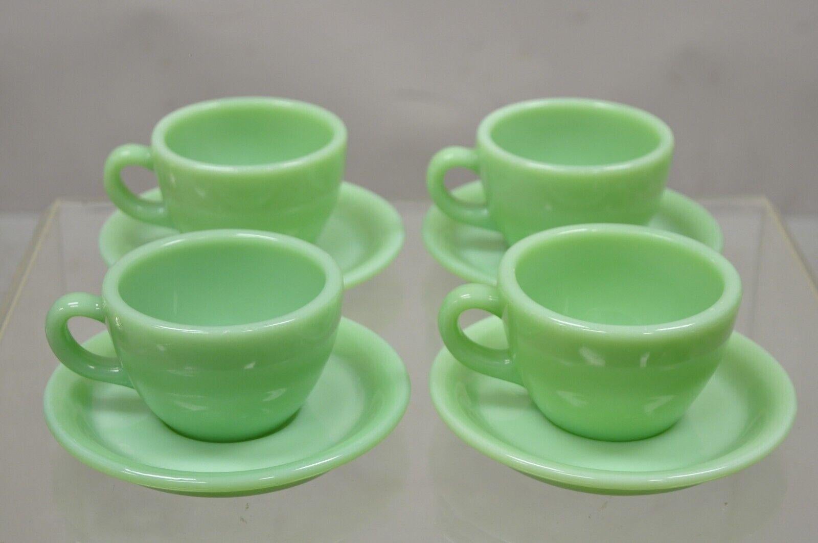 Vintage Fire King Jadeite Green Oven Ware Coffee Cup and Saucer - Set of 4. Circa Mid 20th Century.
Measurements: 
(4) Cups: 2.5