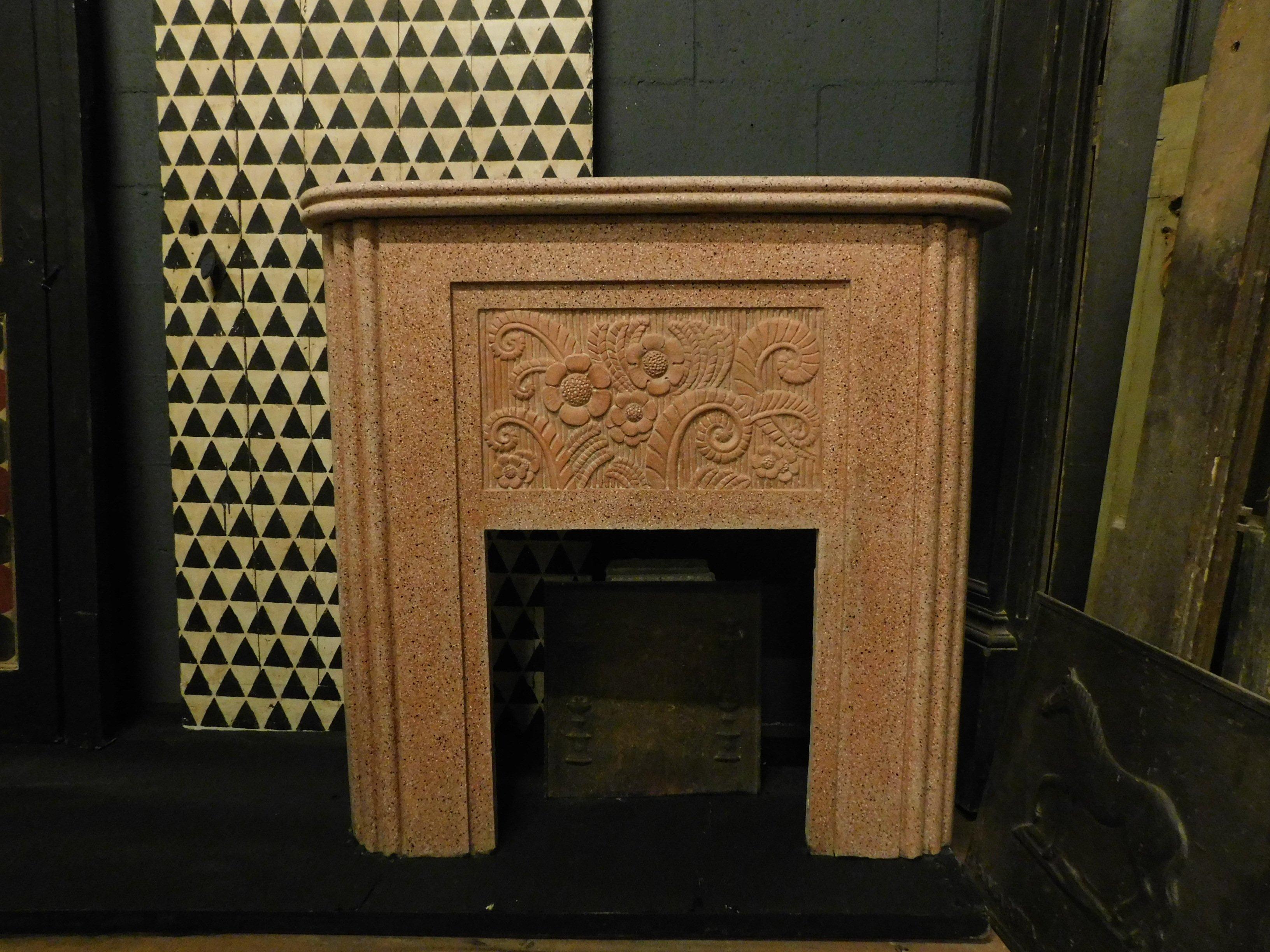Vintage fireplace in red grit, with sculpted flowers and curves typical of the 20th century Italian style, deco style, it was a couple in the same house with a white fireplace of the same design, of great design and effect, ideal for an apartment