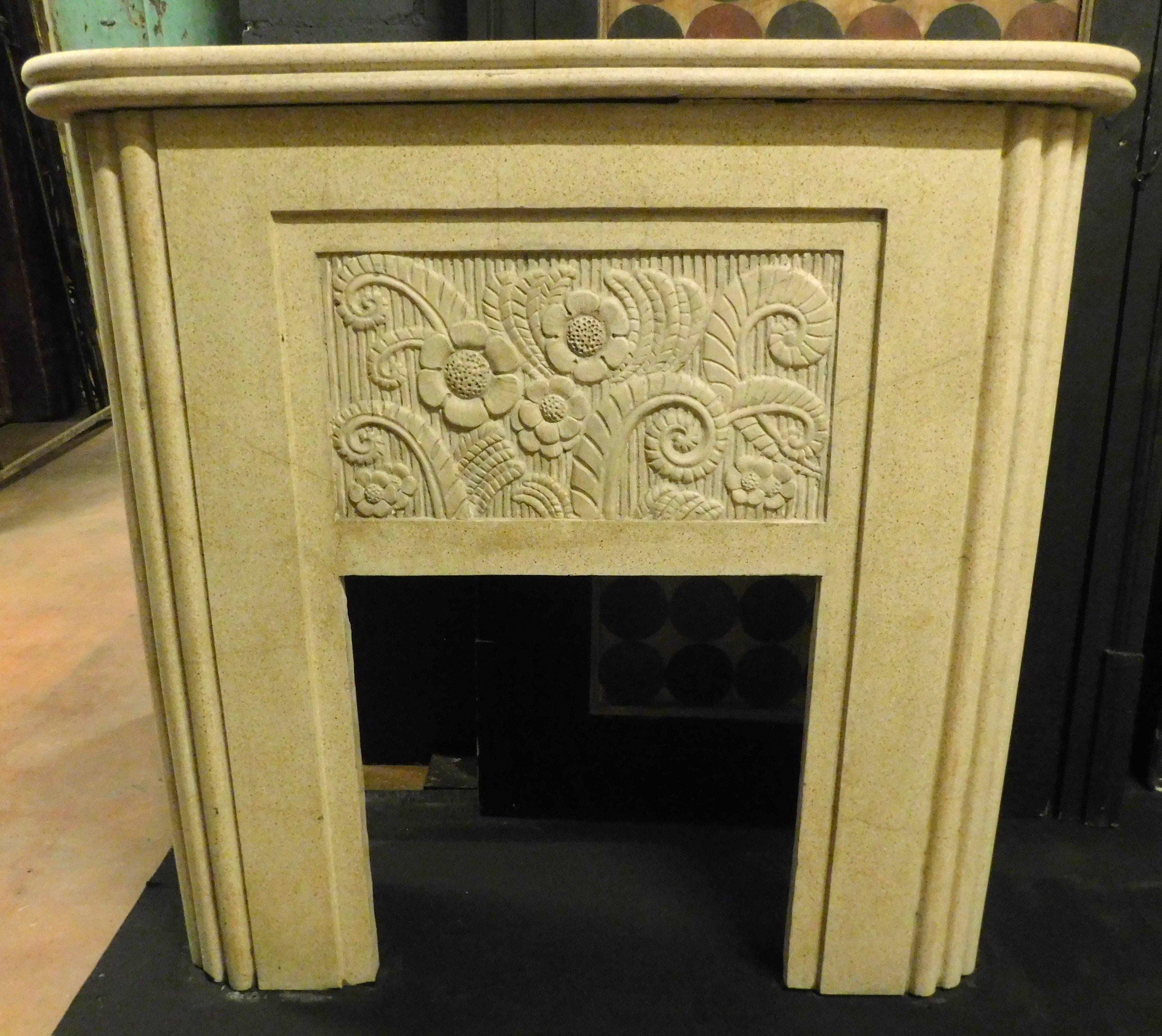 Vintage fireplace in white grit, with sculpted flowers and curves typical of the 20th century Italian style, deco style, it was a couple in the same house with a red fireplace of the same design, of great design and effect, ideal for an apartment