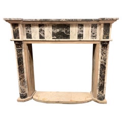 Vintage fireplace mantle in white marble with black inlays, italy