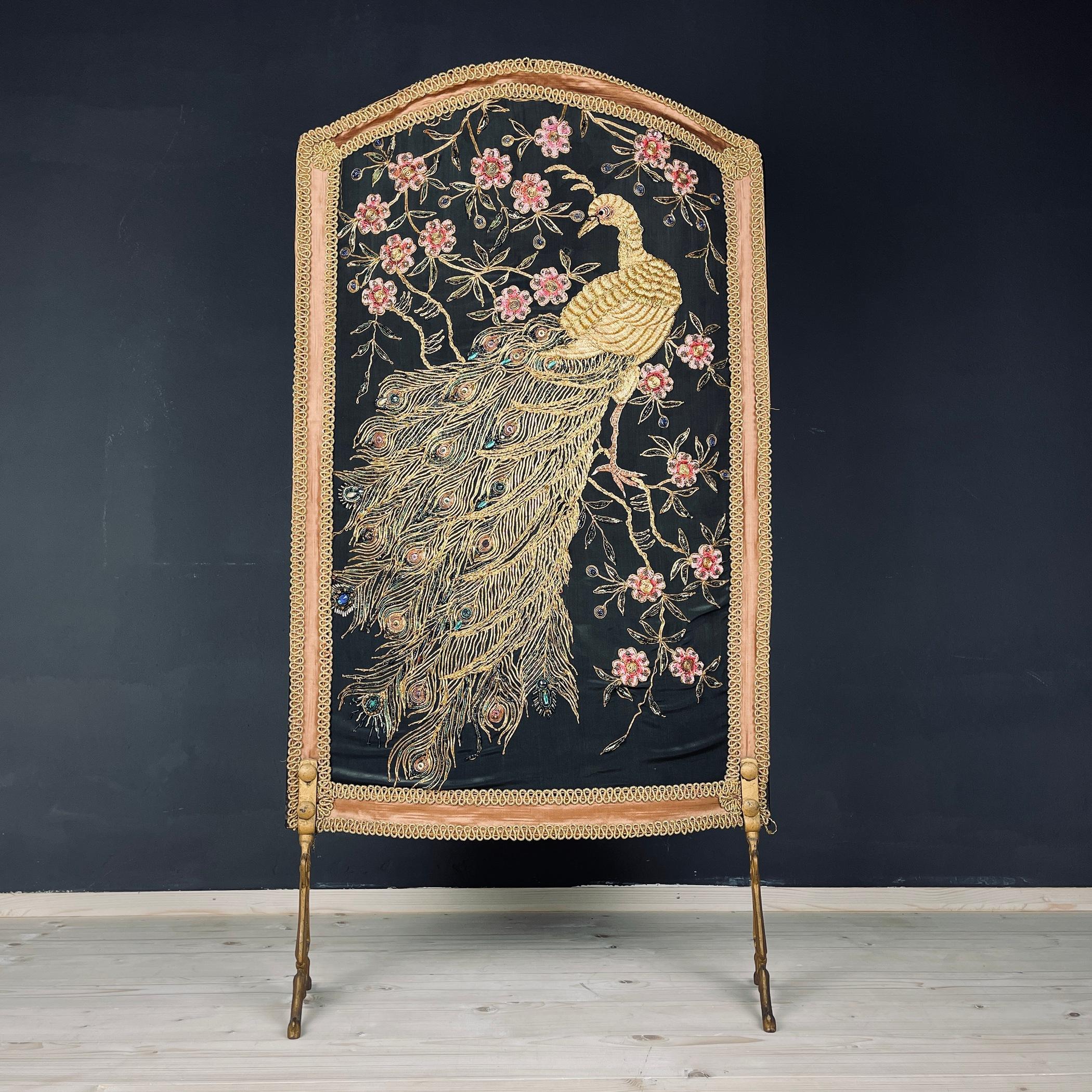 Rare vintage fireplace screen made in Italy in the 30s and 40s. A fire screen is a flat, movable piece of furniture placed in front of a fireplace to dampen heat or excessive light caused by a flame. The fireplace screen rests on two bronze feet.