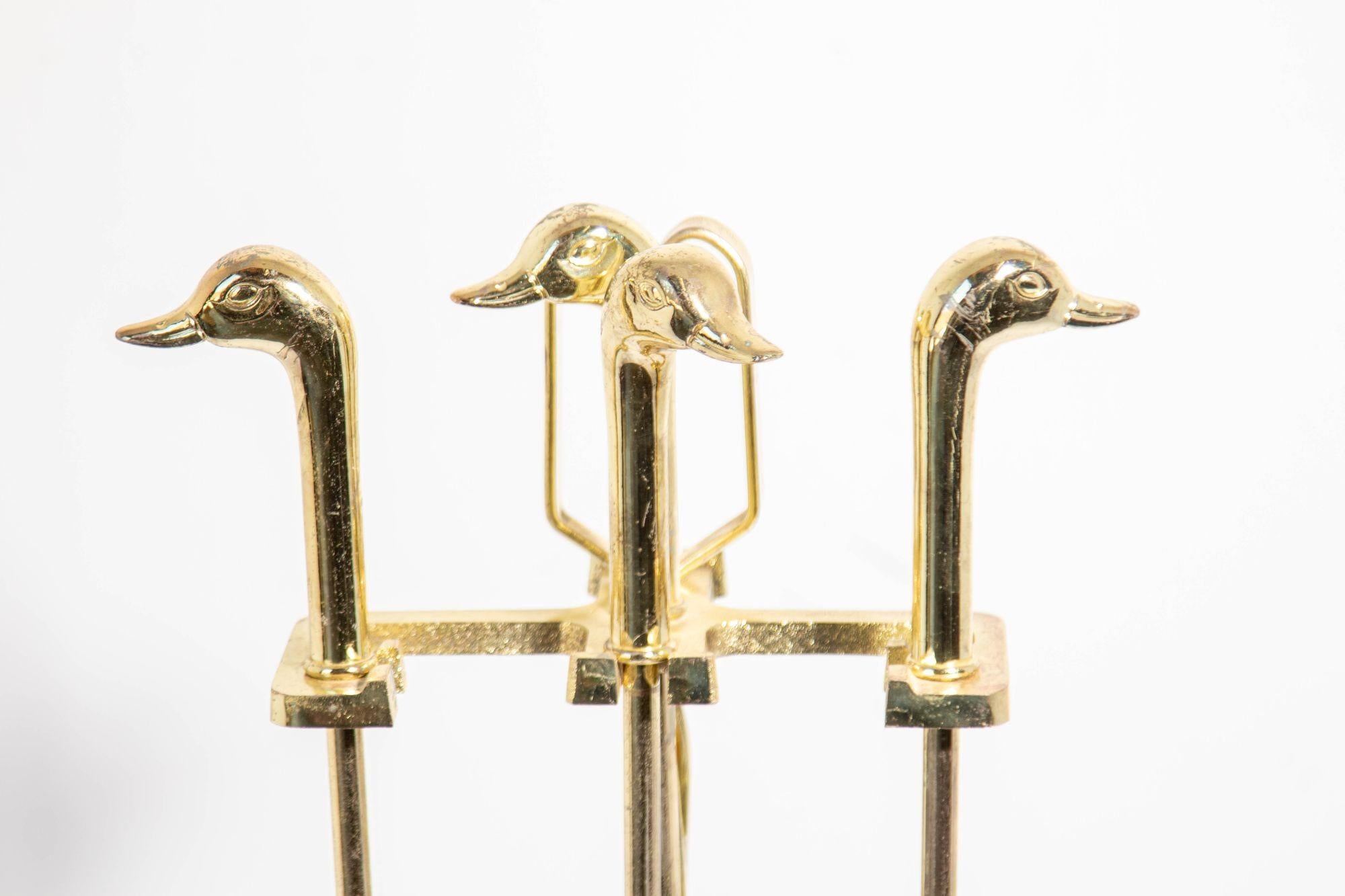 Vintage Fireplace tools in brass metal plated color with duck Mallard heads, circa 1980.
Vintage fireplace tools in brass lacquered with duck heads, French style.
Five-pieces, fireplace tool set features a brass lacquered metal frame and four metal