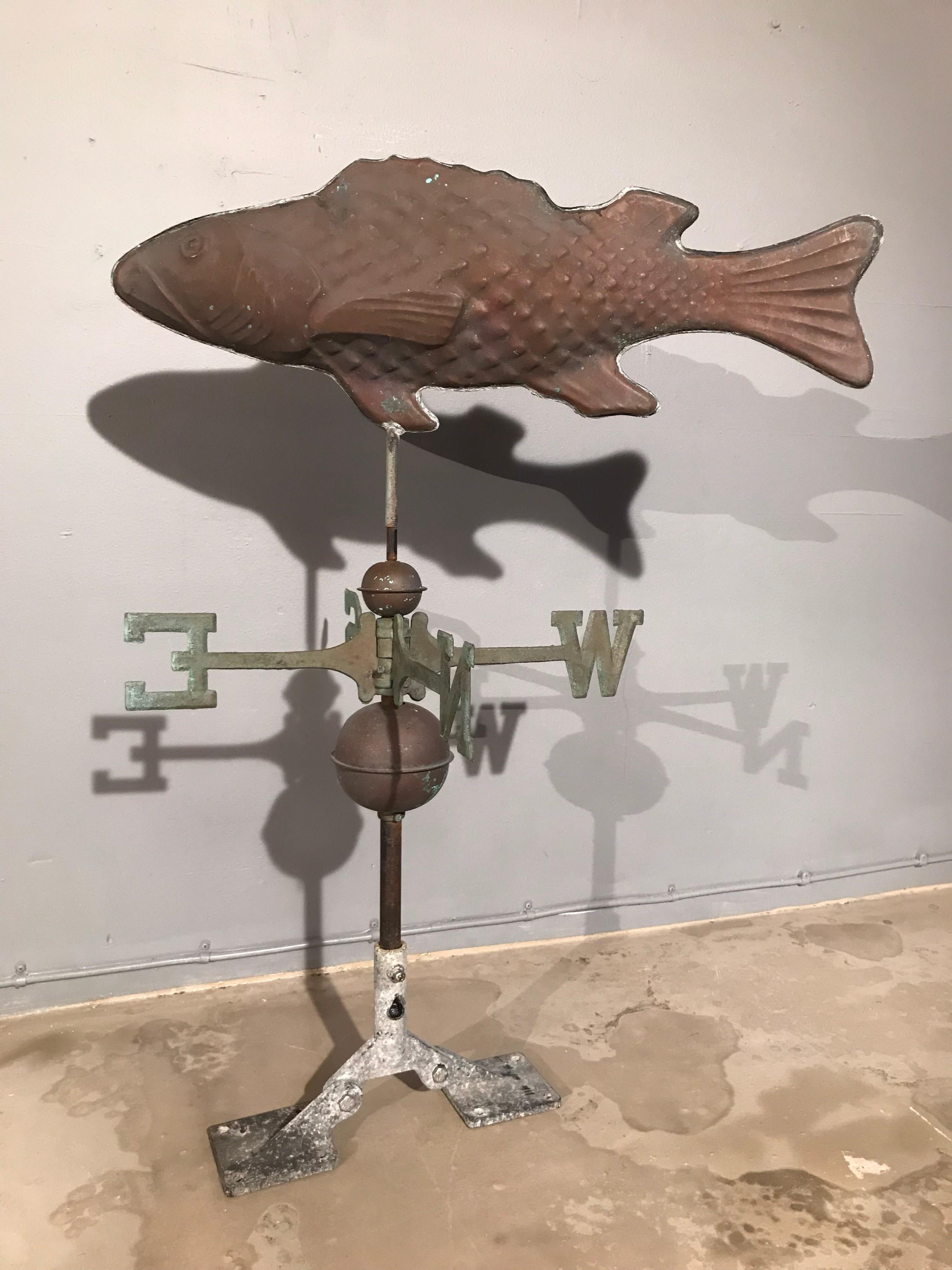 Vintage fish weathervane in copper and steel.
Lovely patina to the surfaces
Copper pressed revolving fish resembles a salmon and is mounted onto a steel rod
The N S E W letters are also copper as are the two globes.
Ready to mount.
 