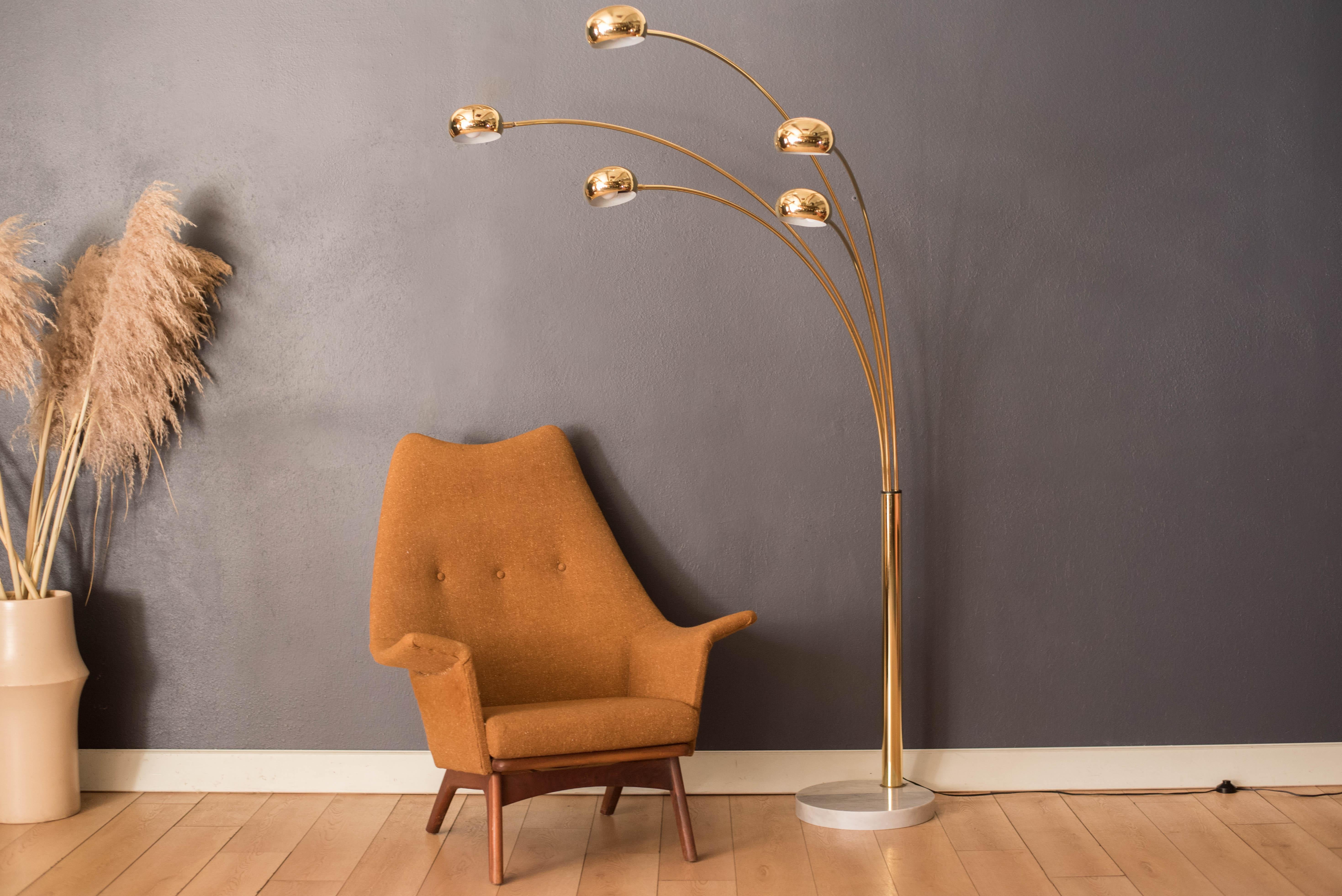 Vintage five arm arc floor lamp circa 1980s. This sculptural piece includes adjustable light shades supported by a sturdy round marble base, marked made in Italy. The perfect statement piece to light up a sectional sofa or living room seating area.
