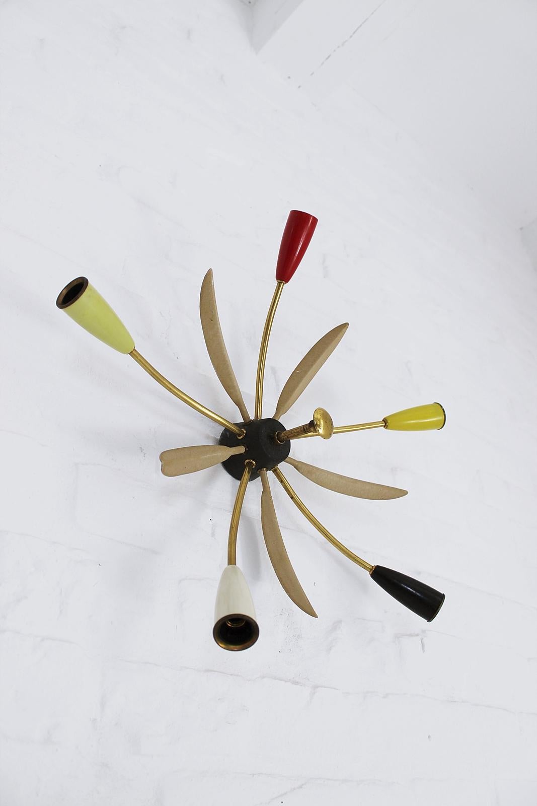 Vintage Mid-Century Modern Sputnik flush mount ceiling lamp from 1950s in Stilnovo style. Each of the five arms has one original E14 socket which is covered by colorful cup. In good condition with a light patina on the brass.