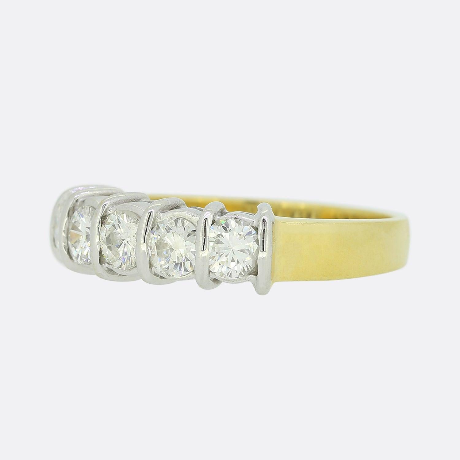 This is a vintage 18ct yellow gold diamond five stone ring. The diamonds are well matched for colour and clarity and sit in bar settings. Although the band of the ring is 18ct yellow gold the diamonds sit in white gold to emphasise their lovely