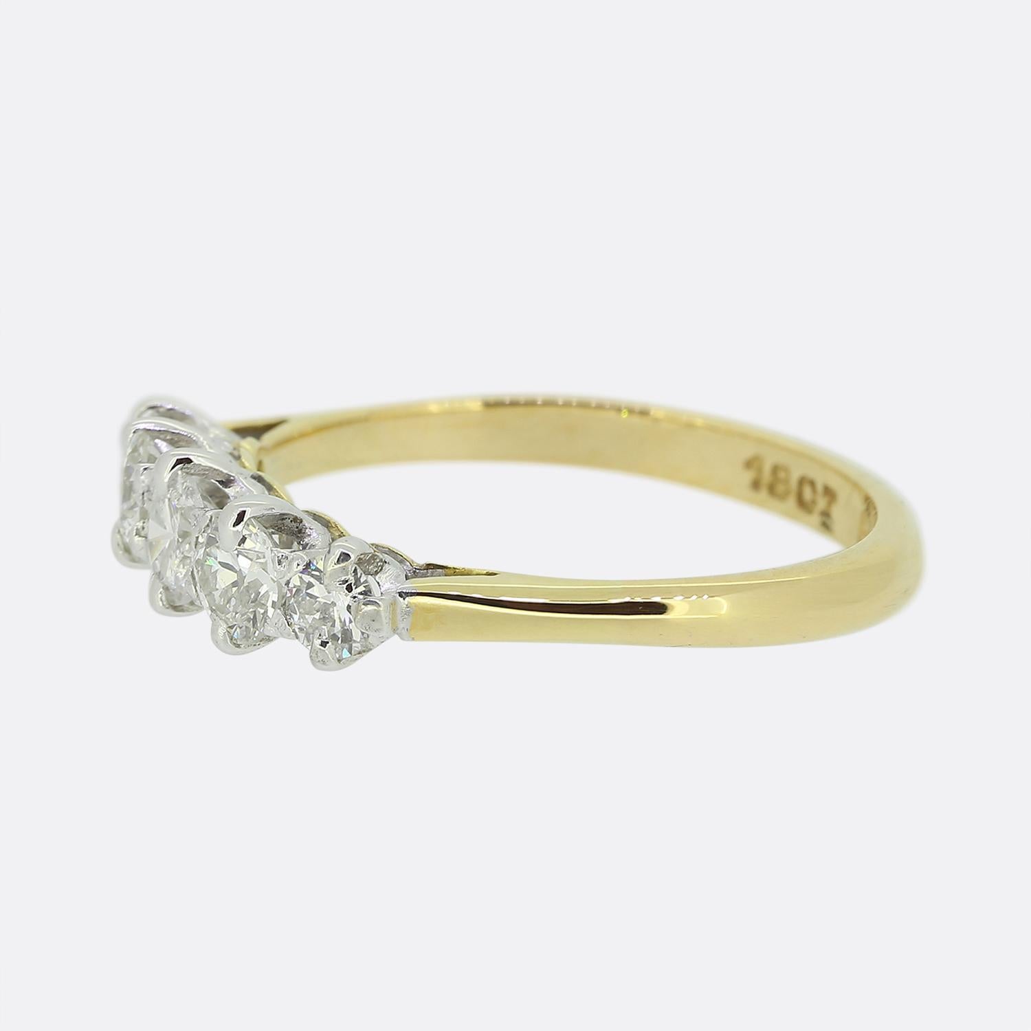 Here we have a classically styled five-stone diamond ring. A single round brilliant cut diamond sits at the centre of the face which is flanked on either side by a duo of round faceted old European cut diamonds. All bright white stones used here