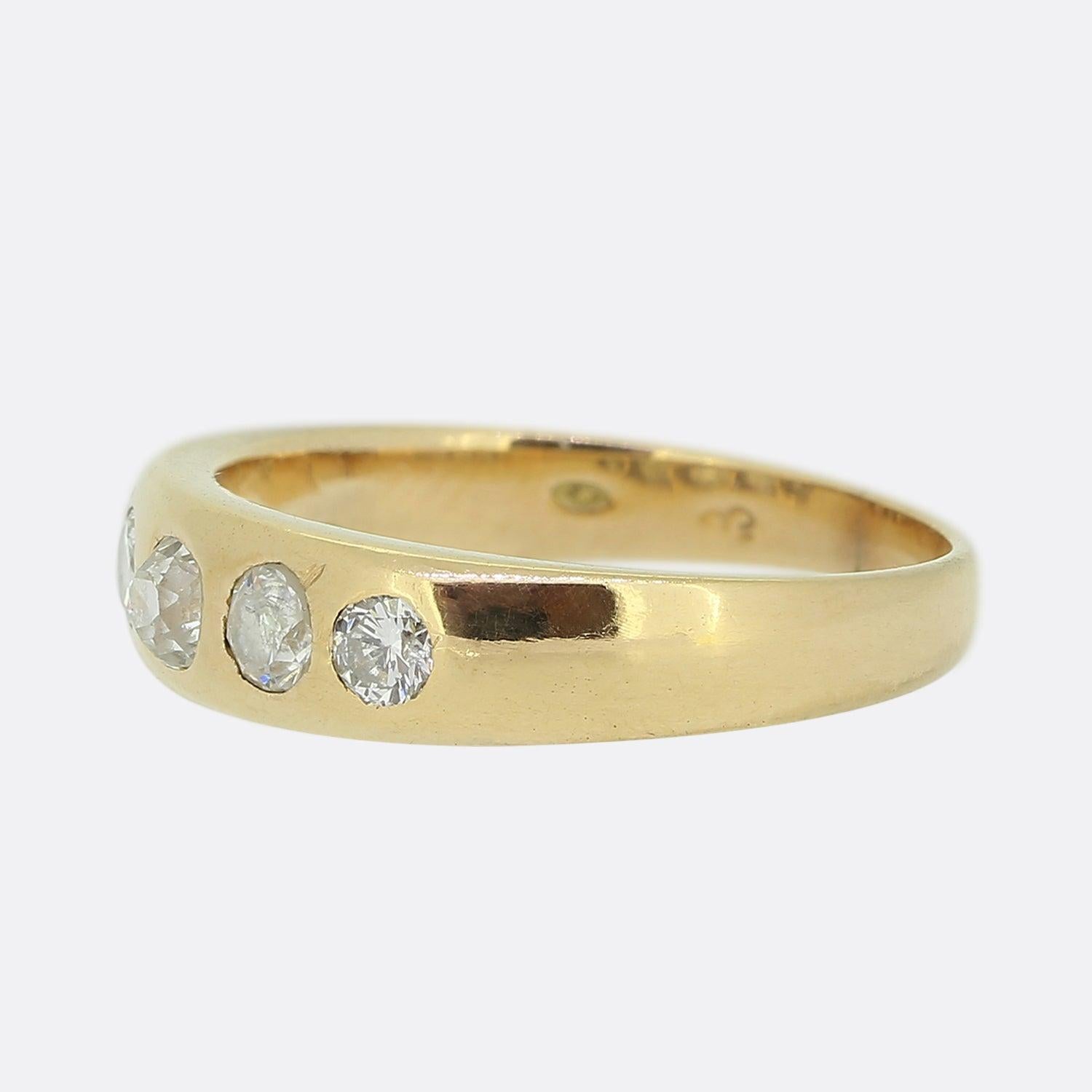 Here we have a classic five-stone diamond ring. This vintage piece has been crafted from 18ct yellow gold and showcases five round faceted natural diamonds in a single line formation; all of which have been individually rub-over set and graduate