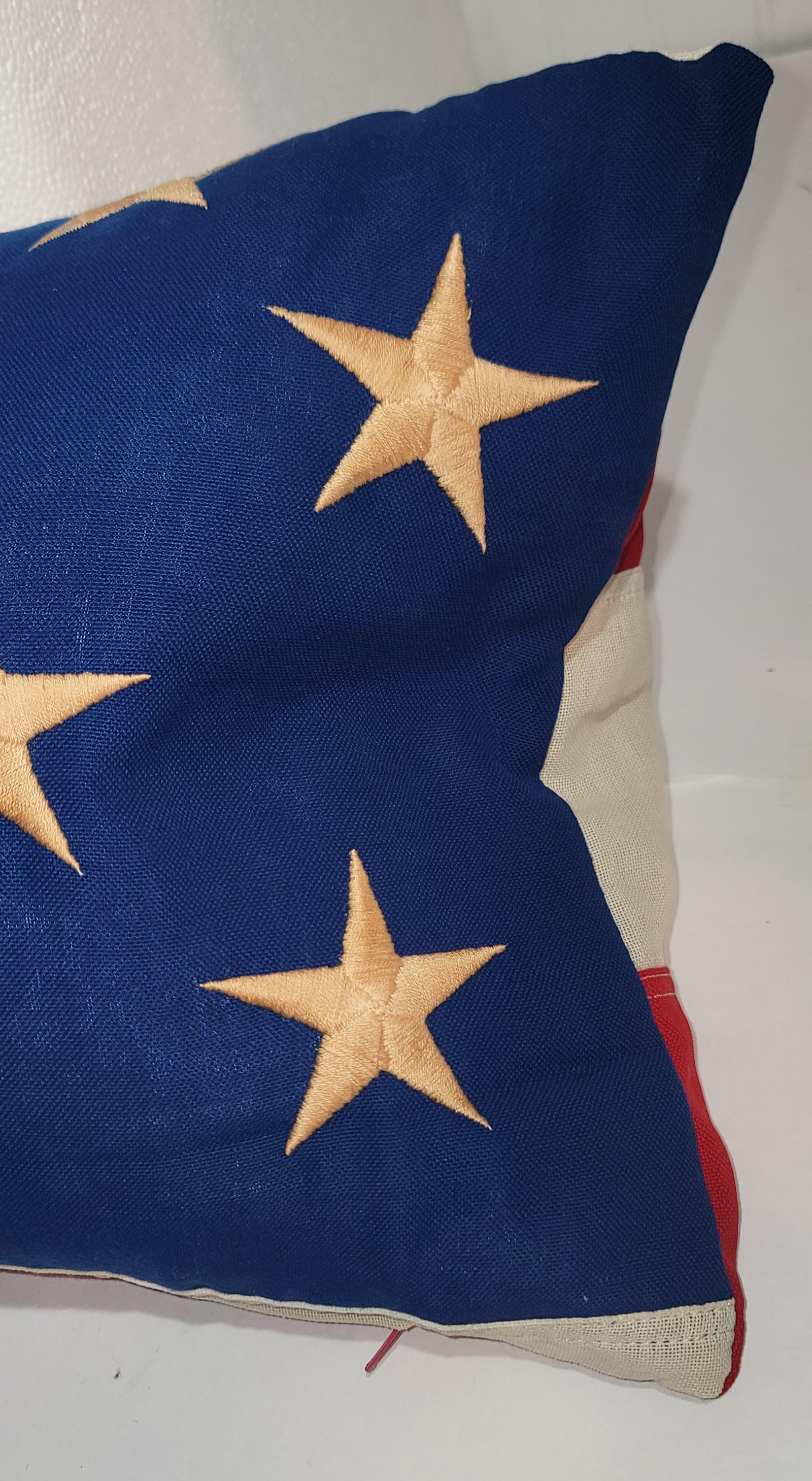 Vintage embroidered flag bolster pillow with red & white stripes backing.The inset is down & feather fill.