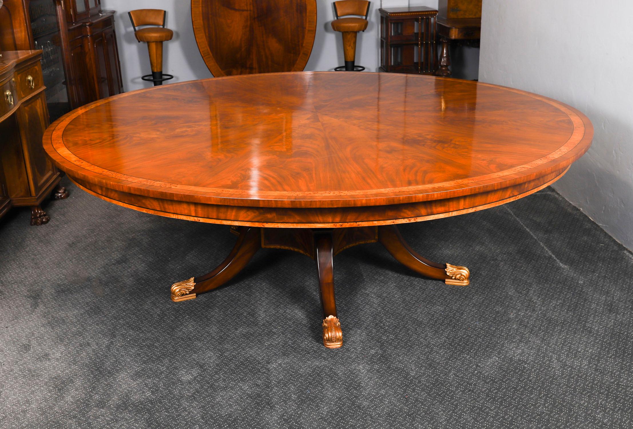 A beautiful Regency Revival flame mahogany dining table dating from the mid 20th century.

The table is of fabulous quality, in excellent condition, can comfortably seat ten and is highly desirable.  A large round table is perfect for dinner parties