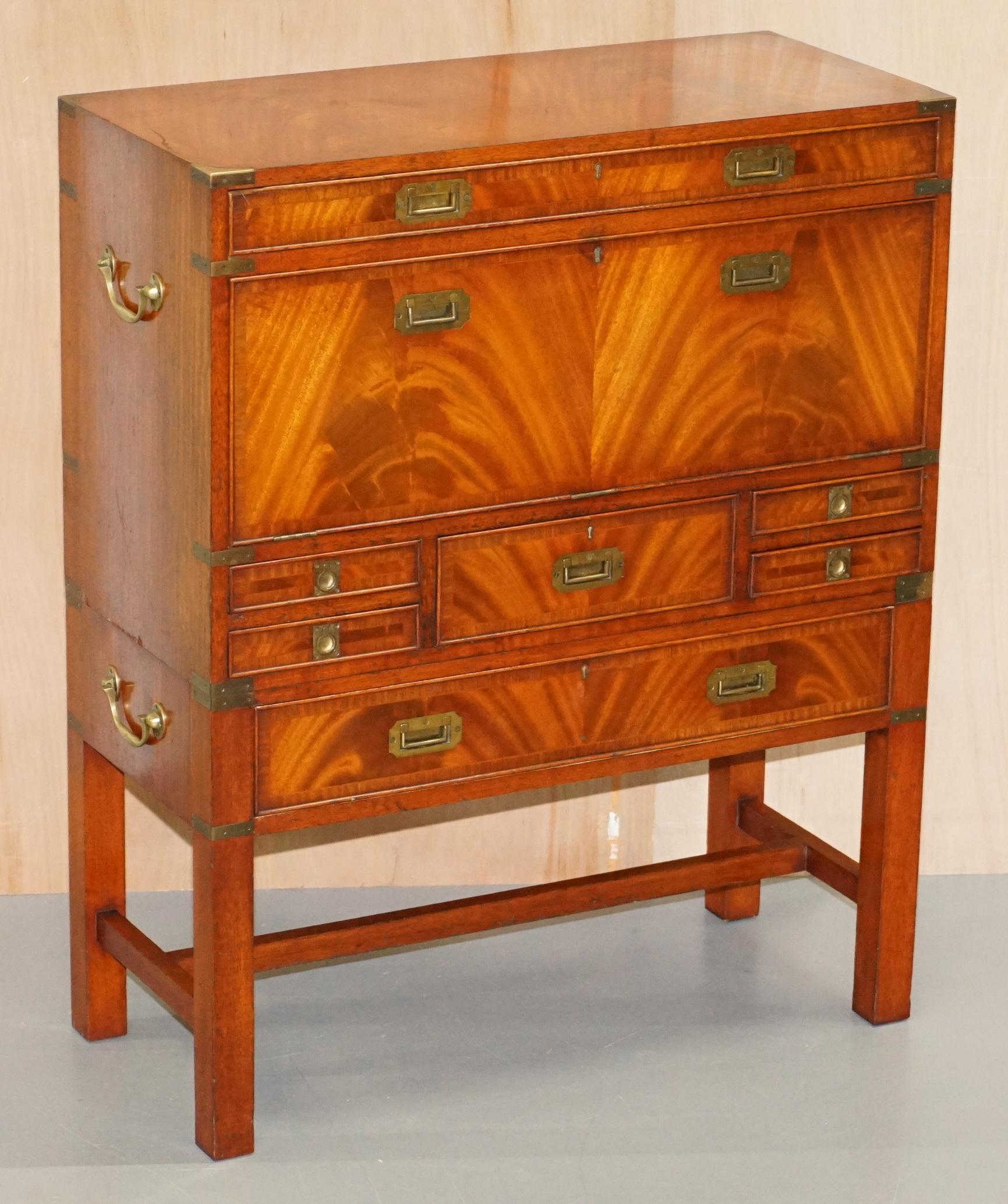 We are delighted to offer for sale this lovely vintage flamed mahogany Military Campaign chest of drawers with drop front desk

A very high quality piece in excellent lightly restored condition throughout, the Campaign chest sits on top of a