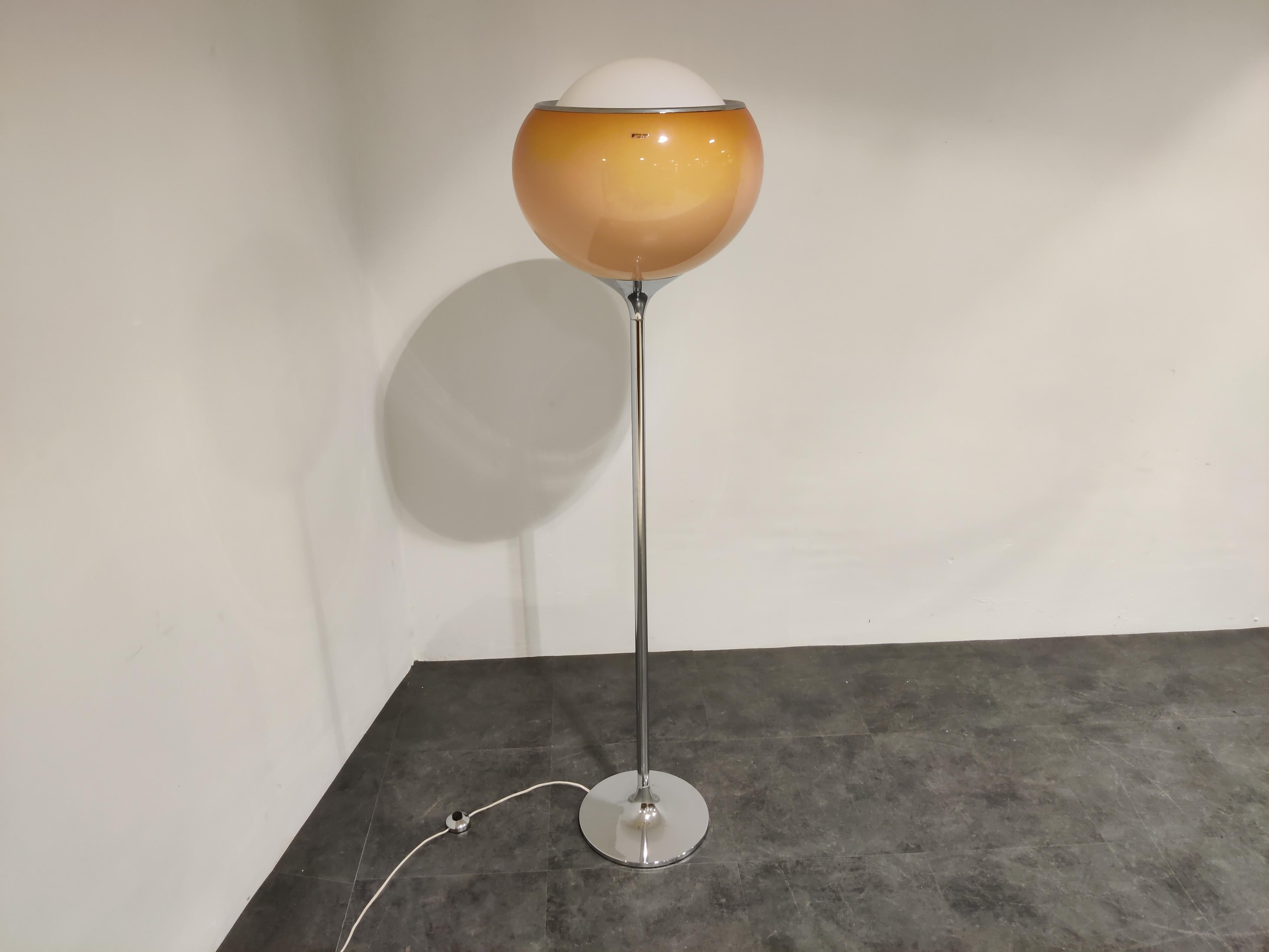 Midcentury floor lamp designed by Studio 6G, the design team of Harvey Guzzini in 1968.

Beautiful chromed base with an acrylic lamp shade creating a very warm and diffuse light.

Elegent and ambient floor lamp with a timeless design. 

1970s
