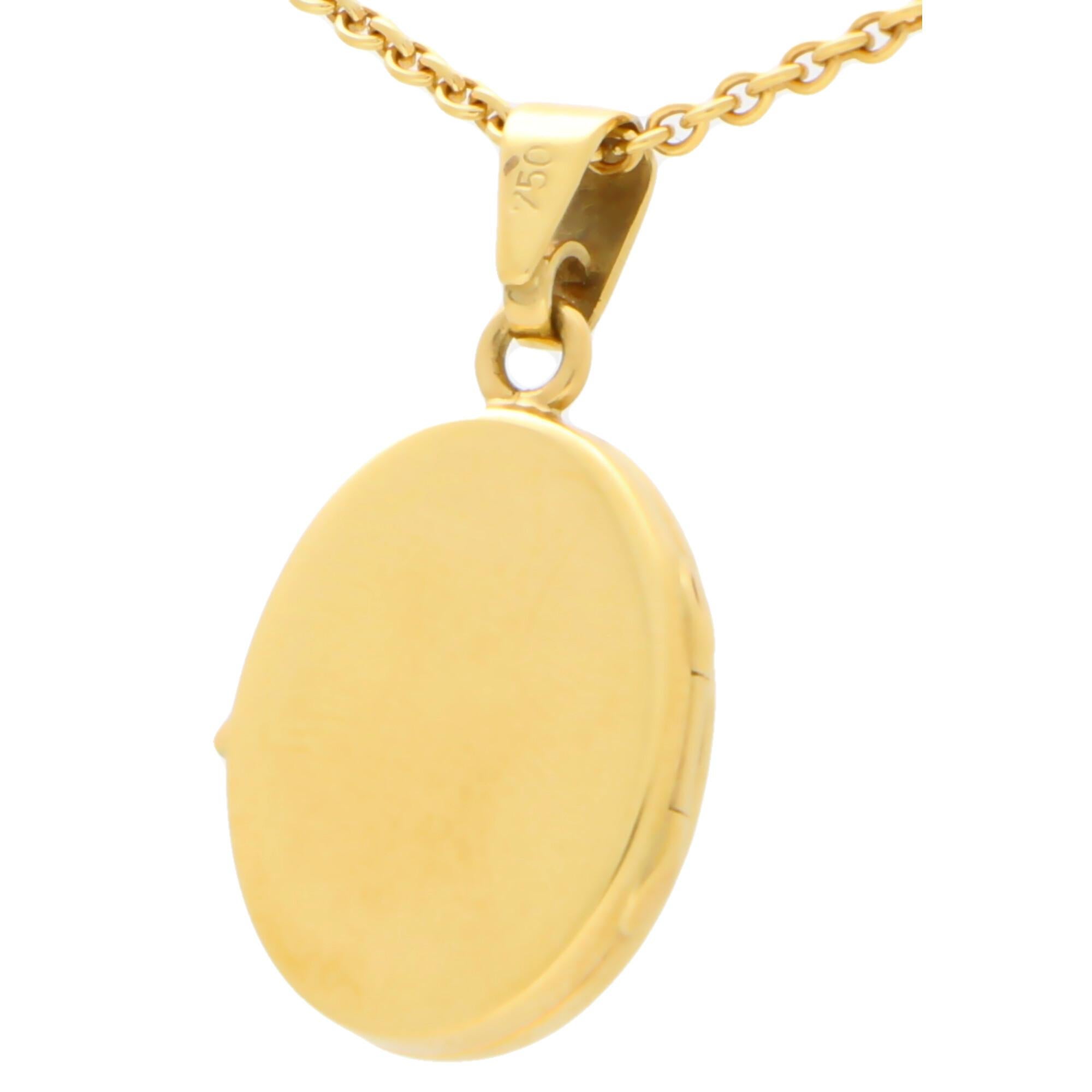 An elegant oval locket set in 18k yellow gold.

The piece is designed in the classic oval locket shape and once opened has two spaces to place small photographs. Due to the design the locket could easily be worn for everyday. The catch on this piece