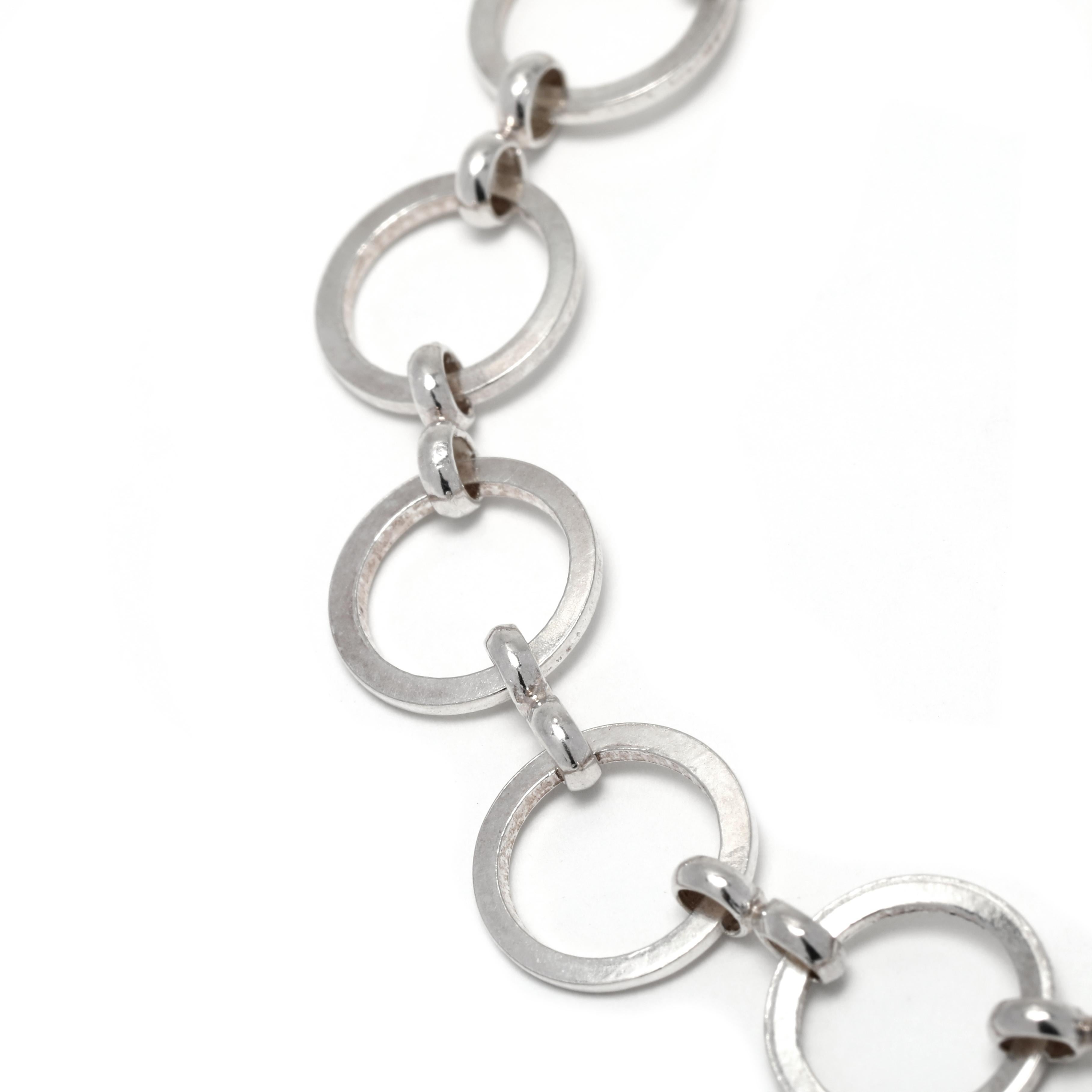 This stunning sterling silver bracelet will add a touch of elegance to any outfit. Featuring a classic flat round link design, this bracelet is crafted with high quality sterling silver and measures 7.25 inches in length. The elegant silver color is
