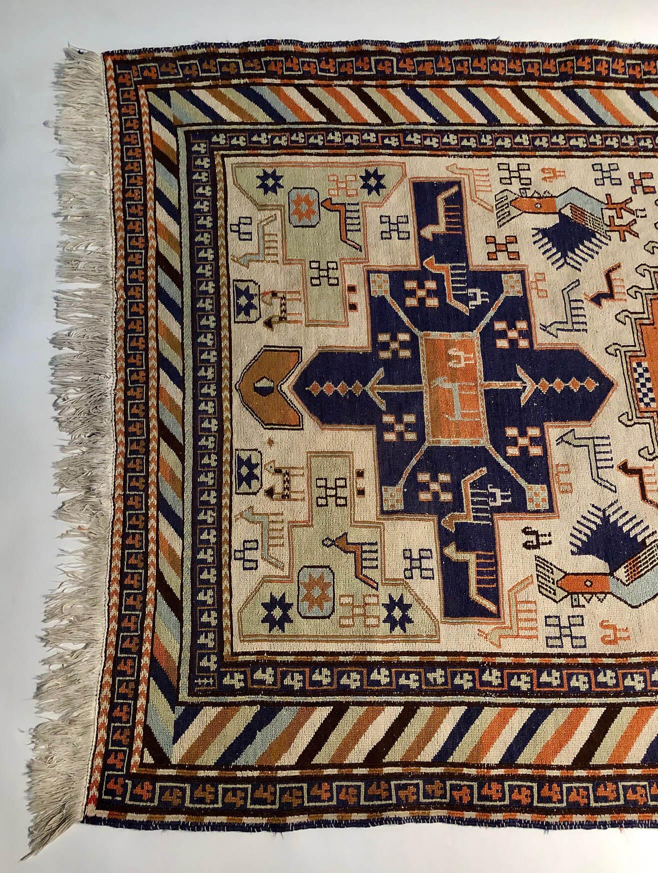 Vintage or semi-antique circa 1970 Persian Heriz Karajeh flat-weave tribal rug having cream ground with navy, orange, brown, light green and blue triple medallion, horse, and bird motifs in field and 'sergeant's stripe' border. 

Produced by women