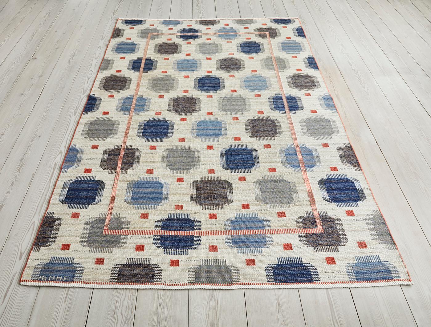 “Blåplump” rug. Handwoven wool in cream with blue and red details. Designed in 1937. Handwoven at Märta Måås-Fjetterström AB, Båstad, Sweden.

Märta Måås-Fjetterström (1873-1941), considered to be Sweden’s greatest textile artist, founded her