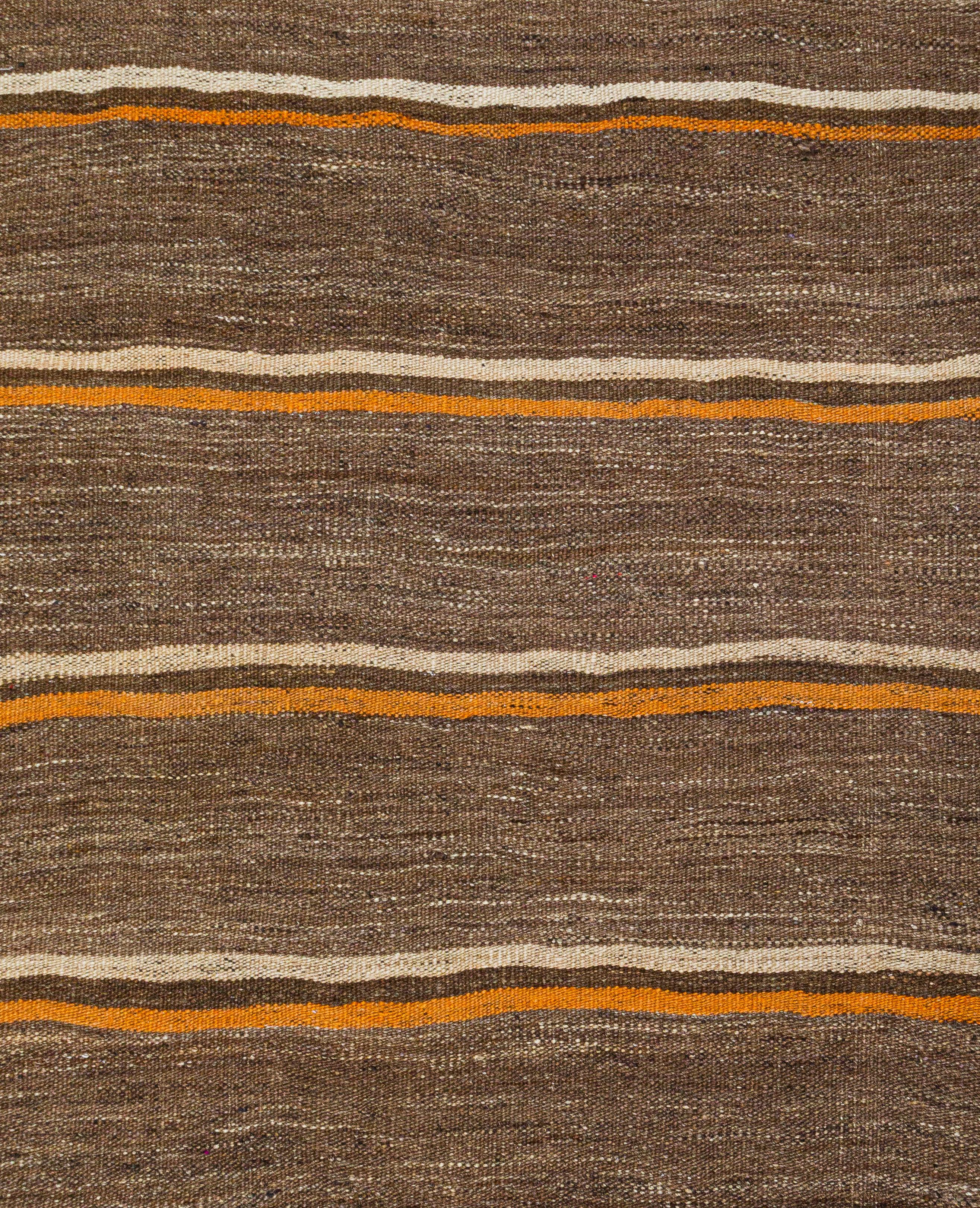 Vintage Flatweave Runner – Timeless Minimalist Craftsmanship

Discover the elegance of this 50-year-old vintage flatweave runner, showcasing a harmonious blend of light brown, beige, and orange stripes. A masterpiece of minimalist craftsmanship,