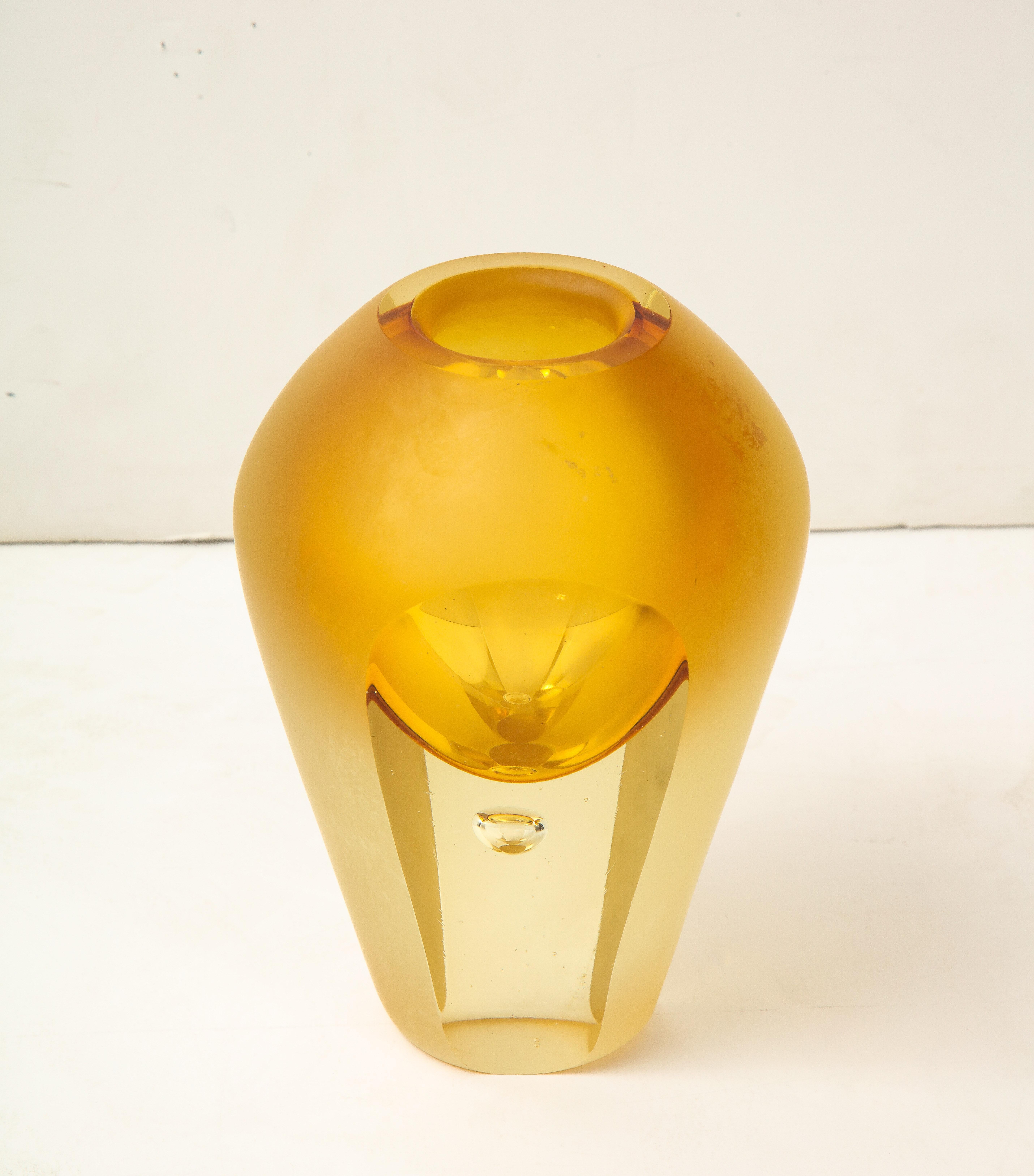 This Vintage Mid-Century Modern vase was made by Flavio Poli in the 1950s in Italy. The materiality features a crystal yellow glass that is triple frosted and triple faceted in the art-deco style. A gorgeous accessory to any room, and is highly