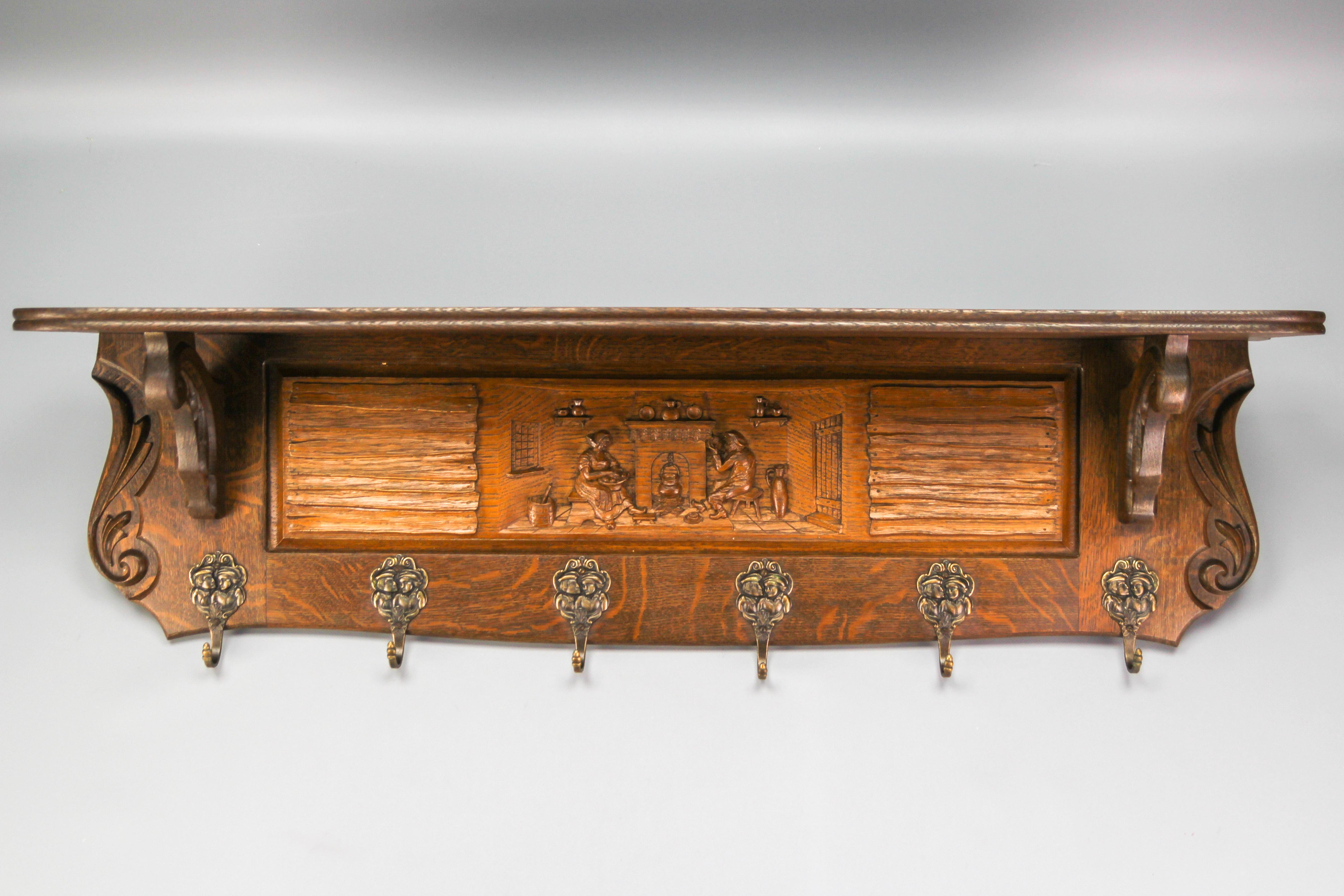Very decorative Flemish hand-carved oakwood wall hanging coat rack with six attractive Breughel style brass figural hooks and interesting carved scenes.
Ideal for hanging coats and hats. It can be also used as well as a kitchen rack for hanging