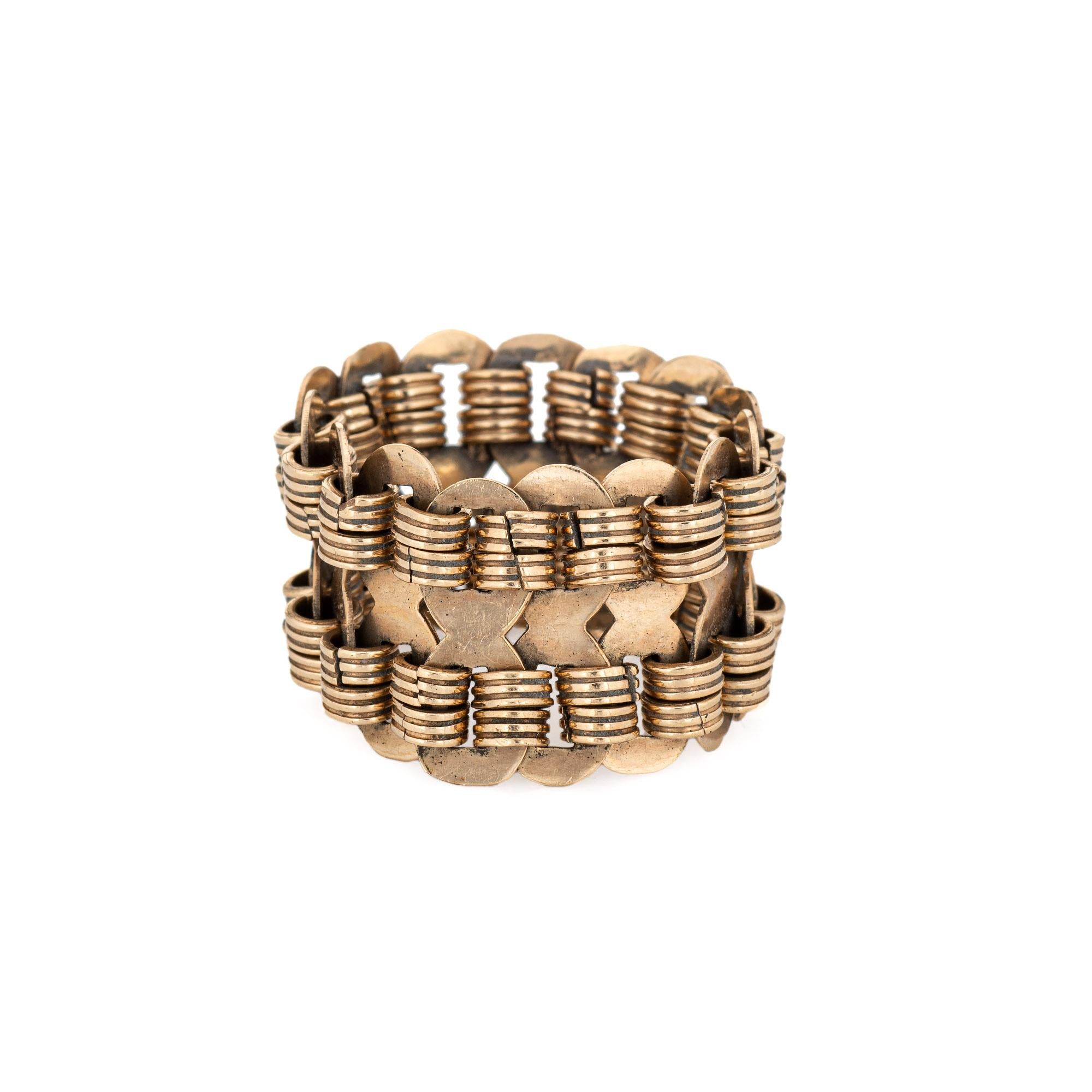 Stylish vintage flex band ring (circa 1970s) crafted in 14 karat yellow gold. 

The wide band (15mm - 0.59 inches) features chain links that join together and meld to the shape of your finger. The ring makes a nice statement on the hand and can be