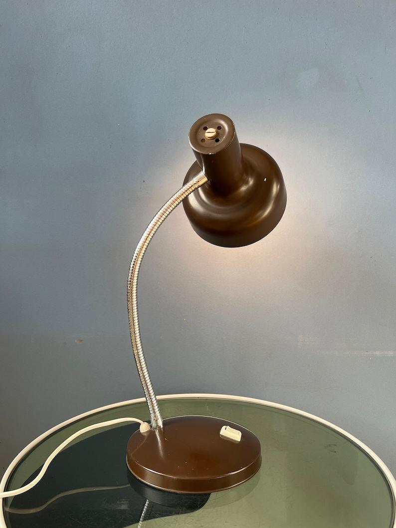 Lampe de table vintage de l'ère spatiale en couleur marron avec bras flexible. Le bras et l'abat-jour peuvent être positionnés de la manière souhaitée. La lampe est en métal. La lampe nécessite une ampoule E27/26 (standard) et dispose actuellement
