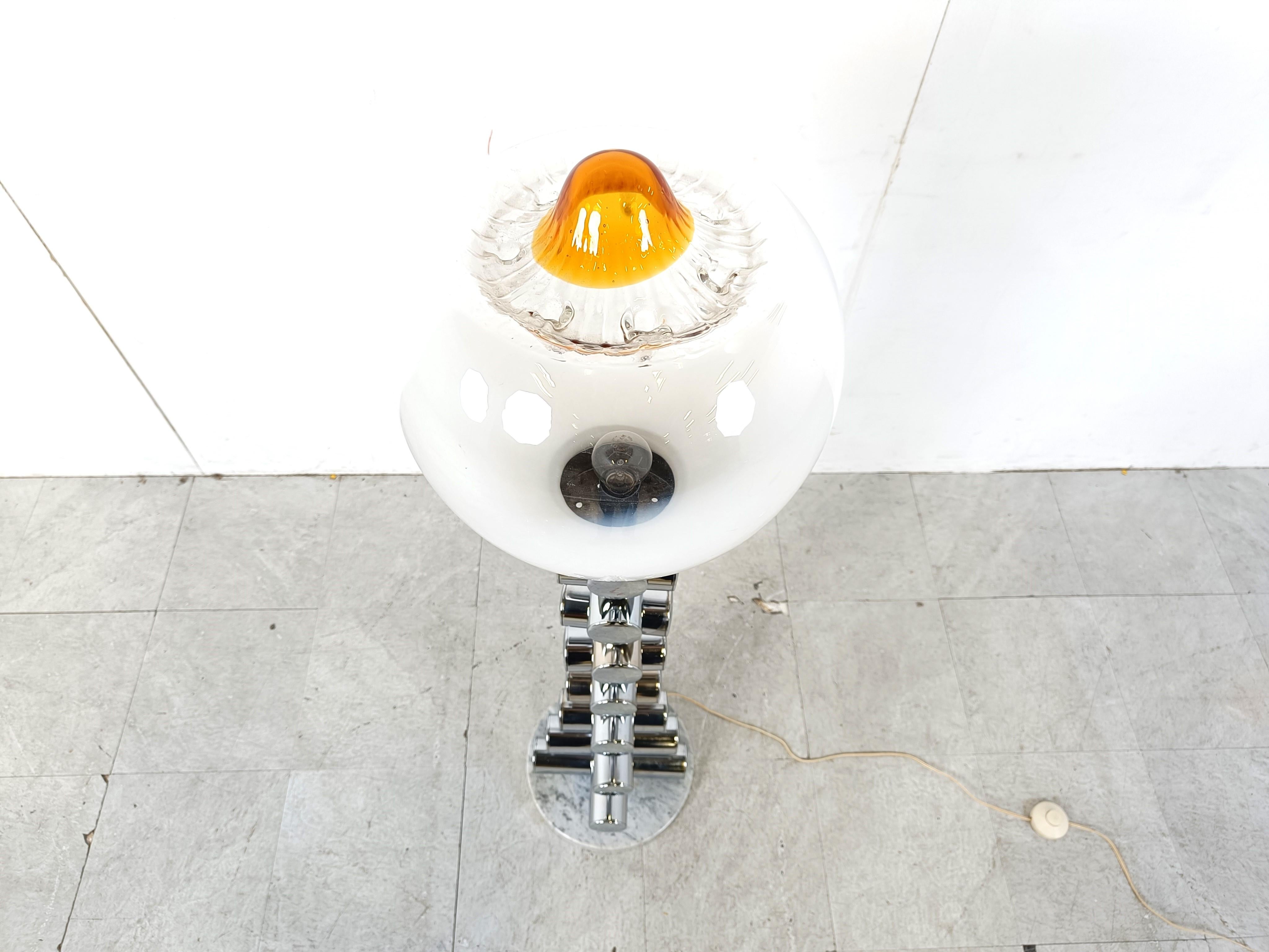 Vintage floor lamp by Mazzega built up by a round white marble base, chromed tubes going from large to small seemingly stacked up on each other supporting a murano glass partially frosted and orange lamp shade.

Striking design.

Tested with a E27