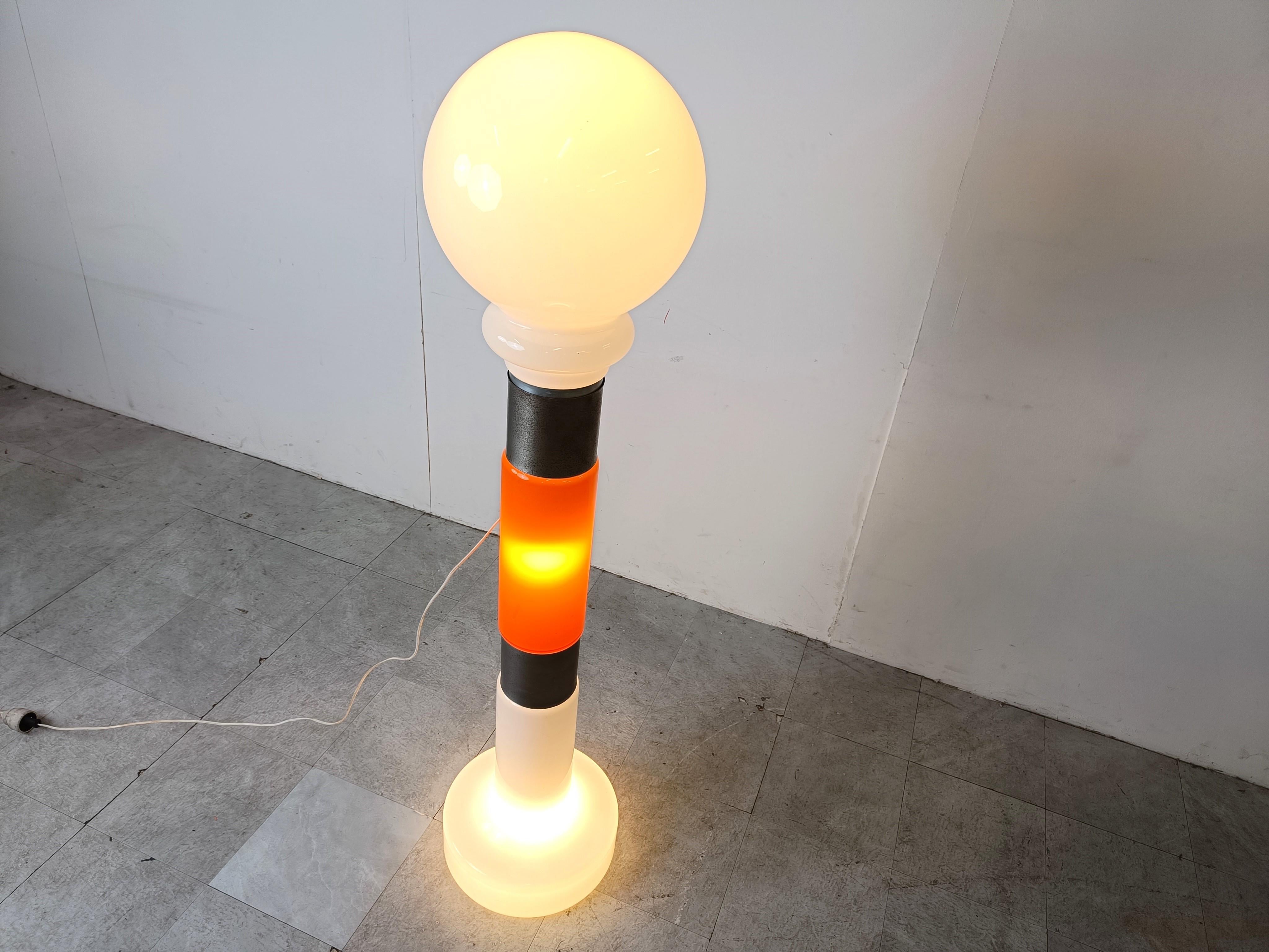 Very rare and striking mid century floor lamp by Mazzega made ou tof orange and white murano glass with two metal rings.

The light emits a beautiful warm light and has three light bulbs; base, center and globe.

Large in size.

Tested and ready to