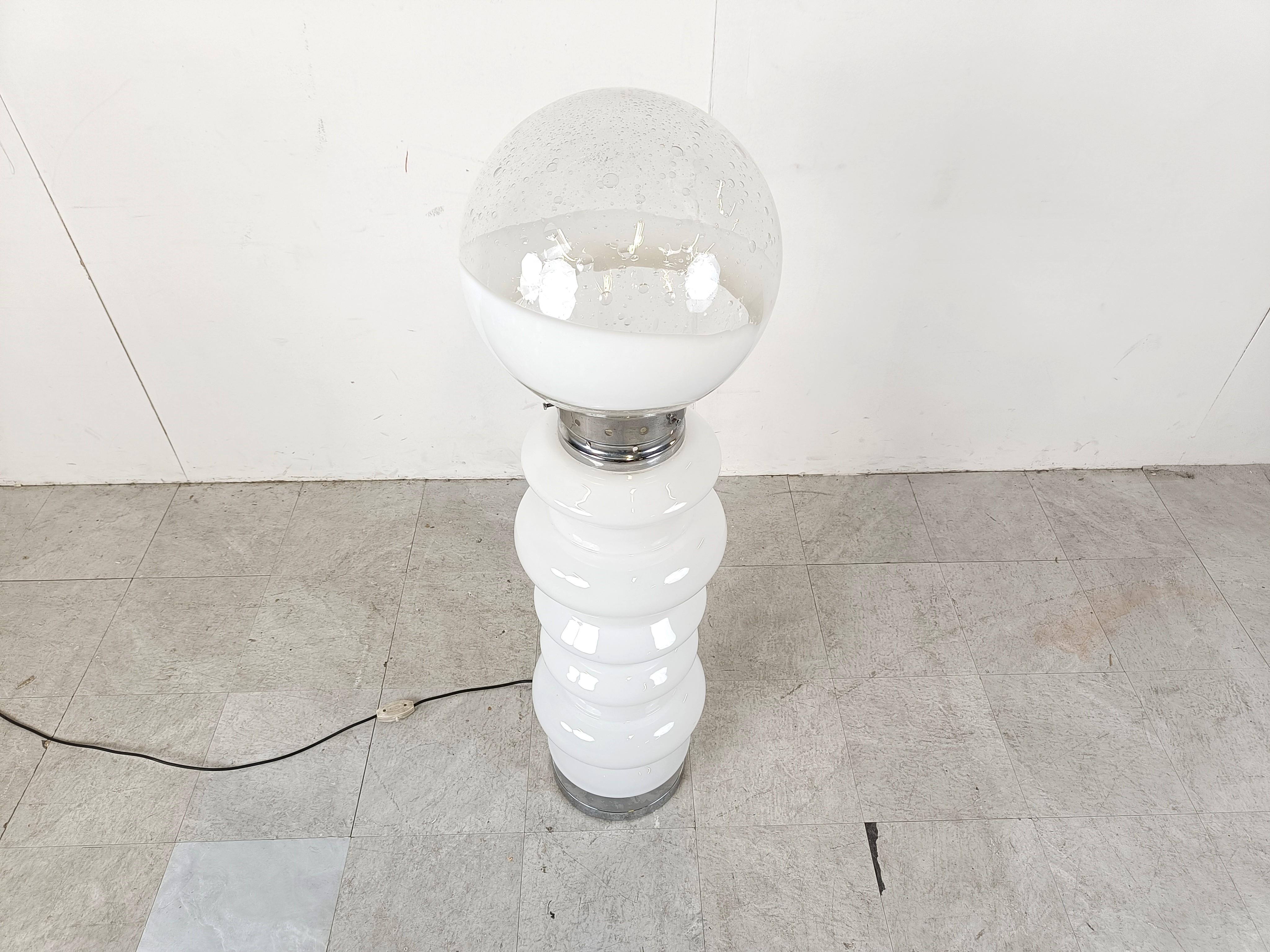 Mid century floor lamp consisting of two white murano glass parts and a globe glass lamp shade.

The floor lamp emits a beautiful light.

Tested and ready to use. 

1960s - Italy

Parts can be individually illuminated

Height: 125cm/49.21