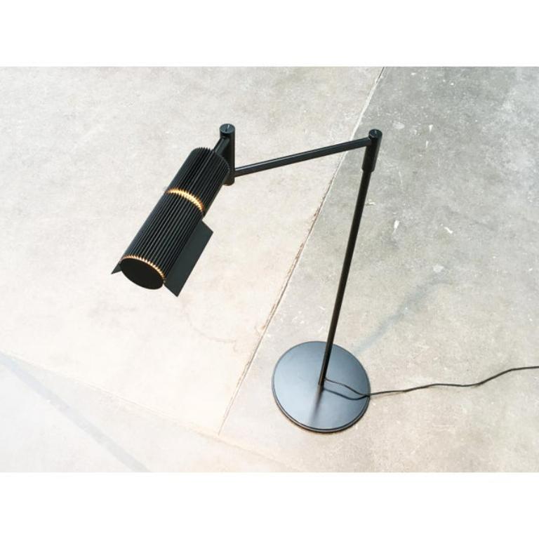 Rare floor lamp from Swisslamps.

The design dates back to the 70s. The floor lamp draws its elegance from a technical design language. This is supported by the completely black color scheme. The fine ribs of the lamp head are particularly striking.