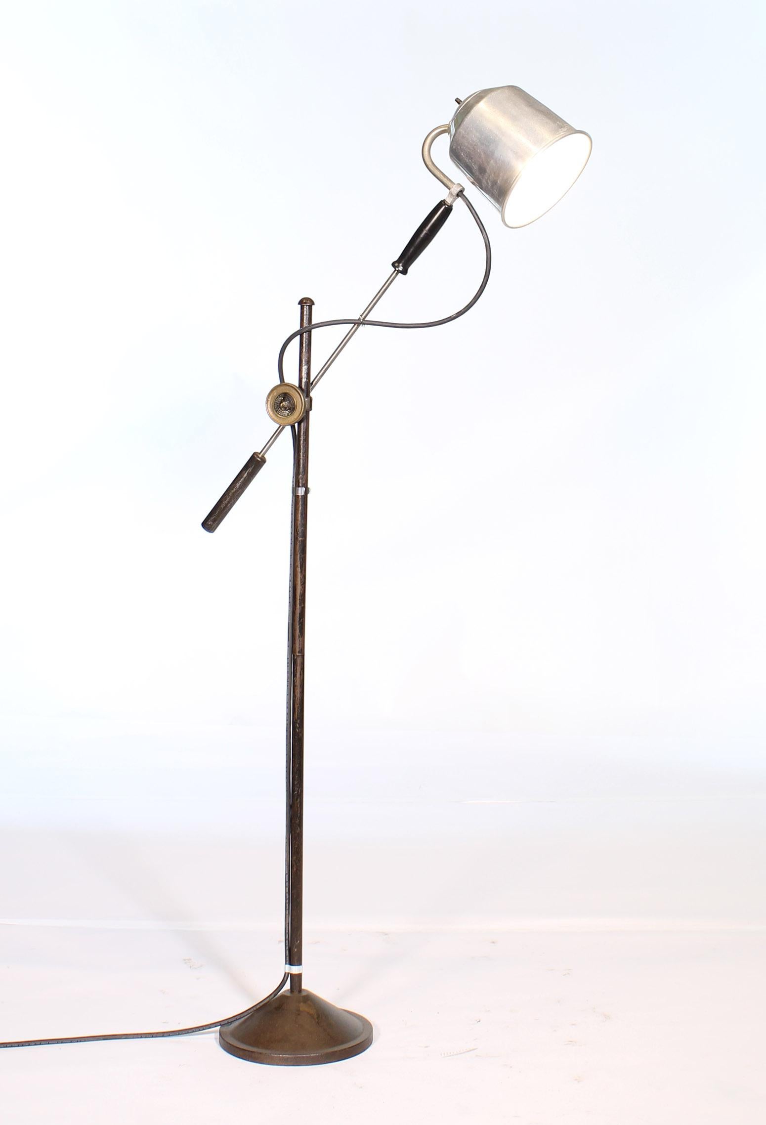 Authentic vintage industrial adjustable floor / reading light made by William Campbell Co. Features solid brass center adjustment fitting, aluminum shade, formed handle and iron base. The lower arm measures 42