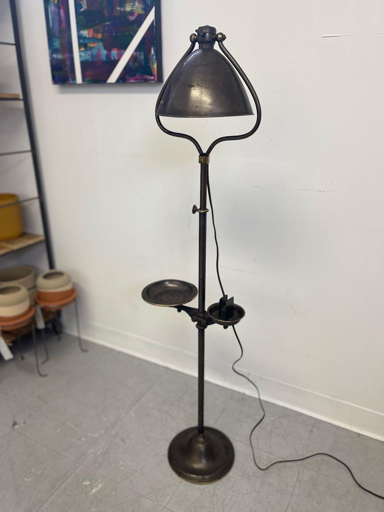This Lamp is Adjustable in a few Different ways. The Head Tilts like a Bell, and the Trunk is Adjustable in height.Lamp Turns on.Beautiful Petina throughput. The Top of the Lamp is  Fully Removable. Vintage Condition Consistent with Age as
