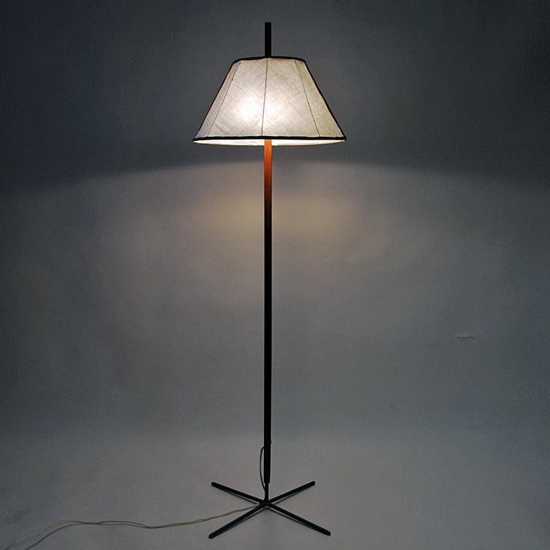 Lovely and elegant teak and iron Floor lamp mod G35 designed by Hans-Agne Jakobsson for Markaryd, Sweden in the 1960s. Cross iron base and teak lamp pole with a new upholstered fabric drum shaped shade in a lowered position on the pole. Perfect lamp