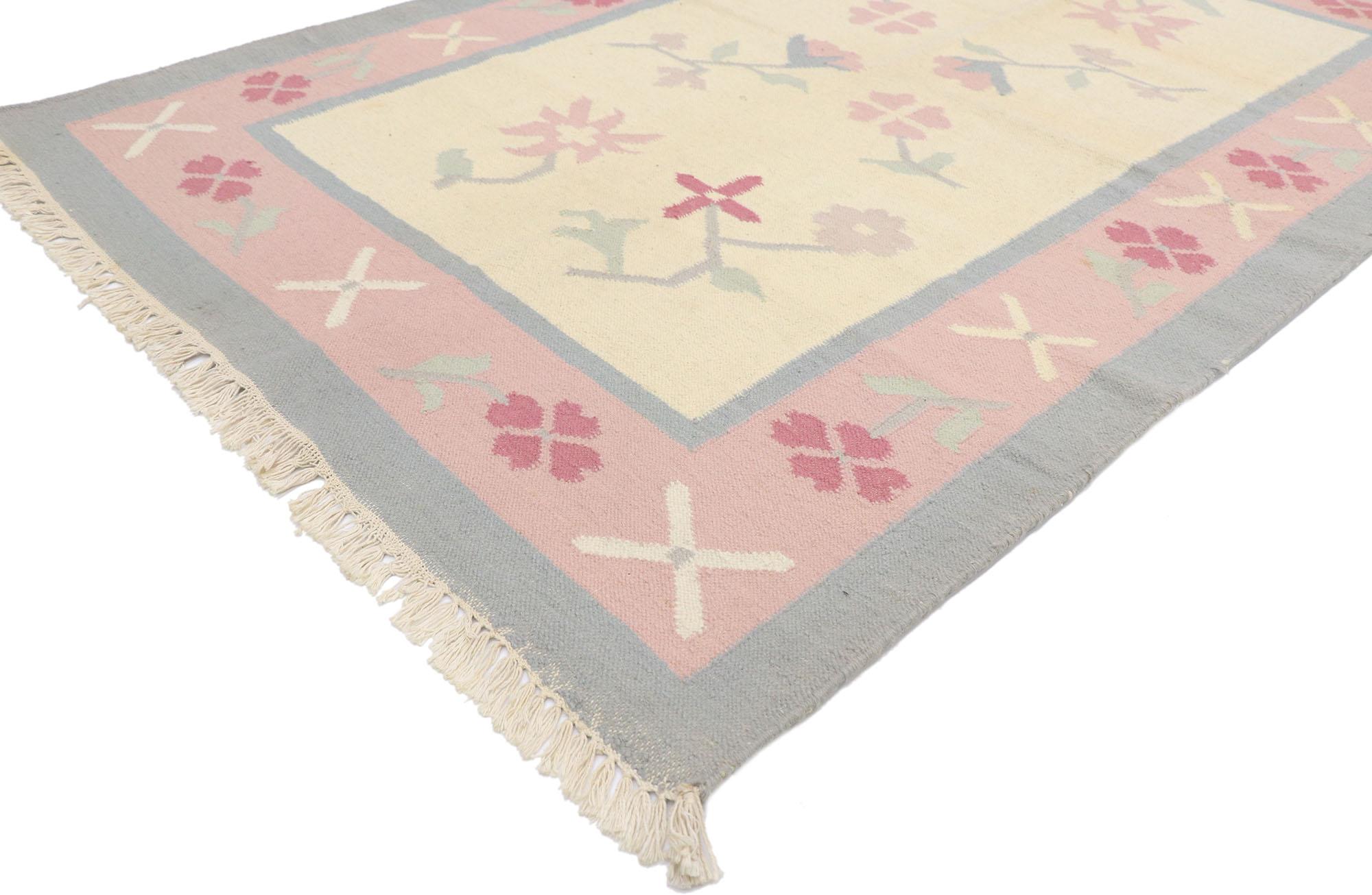77817 vintage Floral Dhurrie rug 04'02 x 06'00. This hand-woven cotton vintage floral Dhurrie rug features a color blocked field and border festooned with gorgeous floral motifs. Stylized florals elegantly float in the abrashed beige field. It is