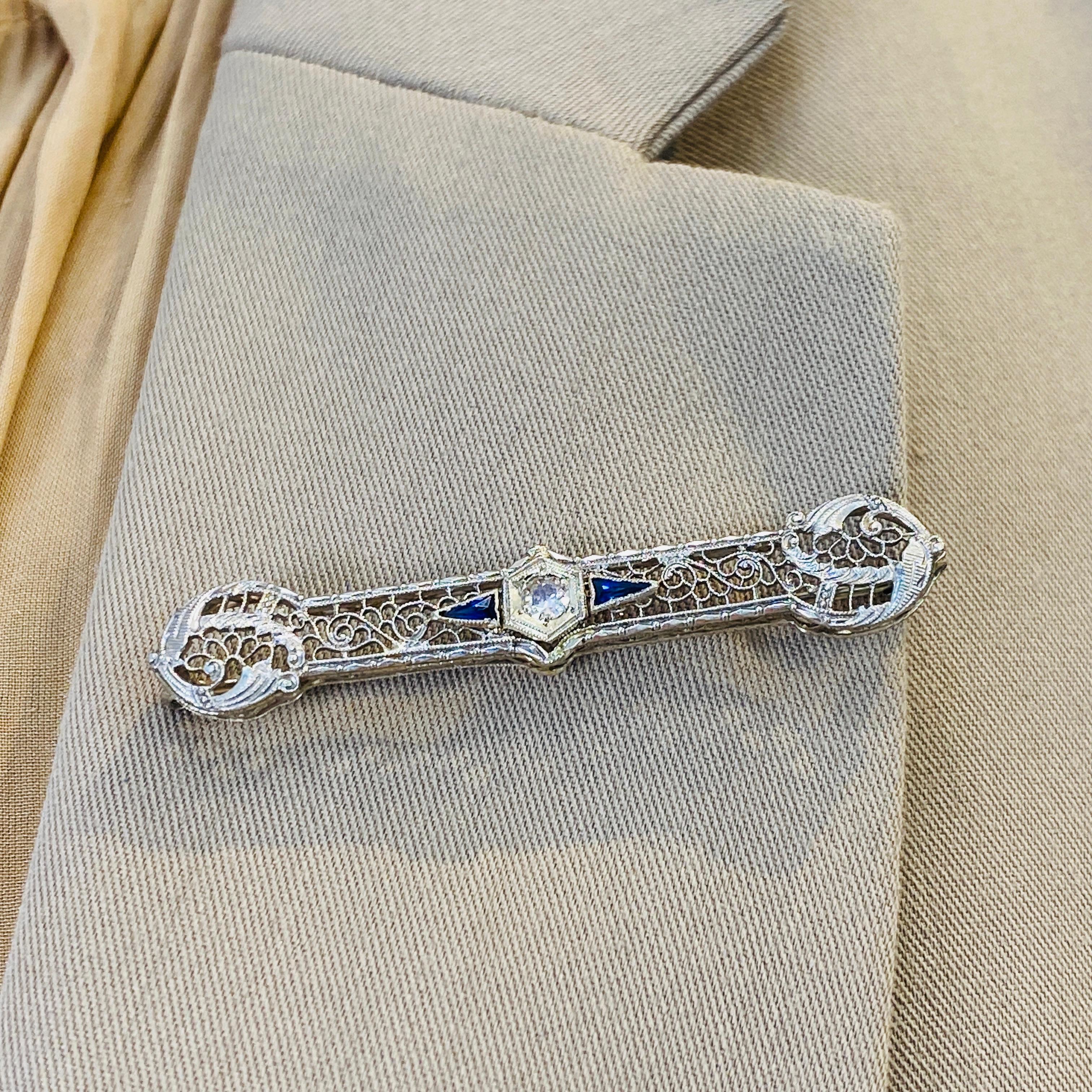 Wear a piece of art from the past with this fanciful floral wirework pin! This is a beautifully made and preserved vintage brooch in 14 karat white gold. A lovely old European cut diamond sits at the center of the brooch and shines bright with