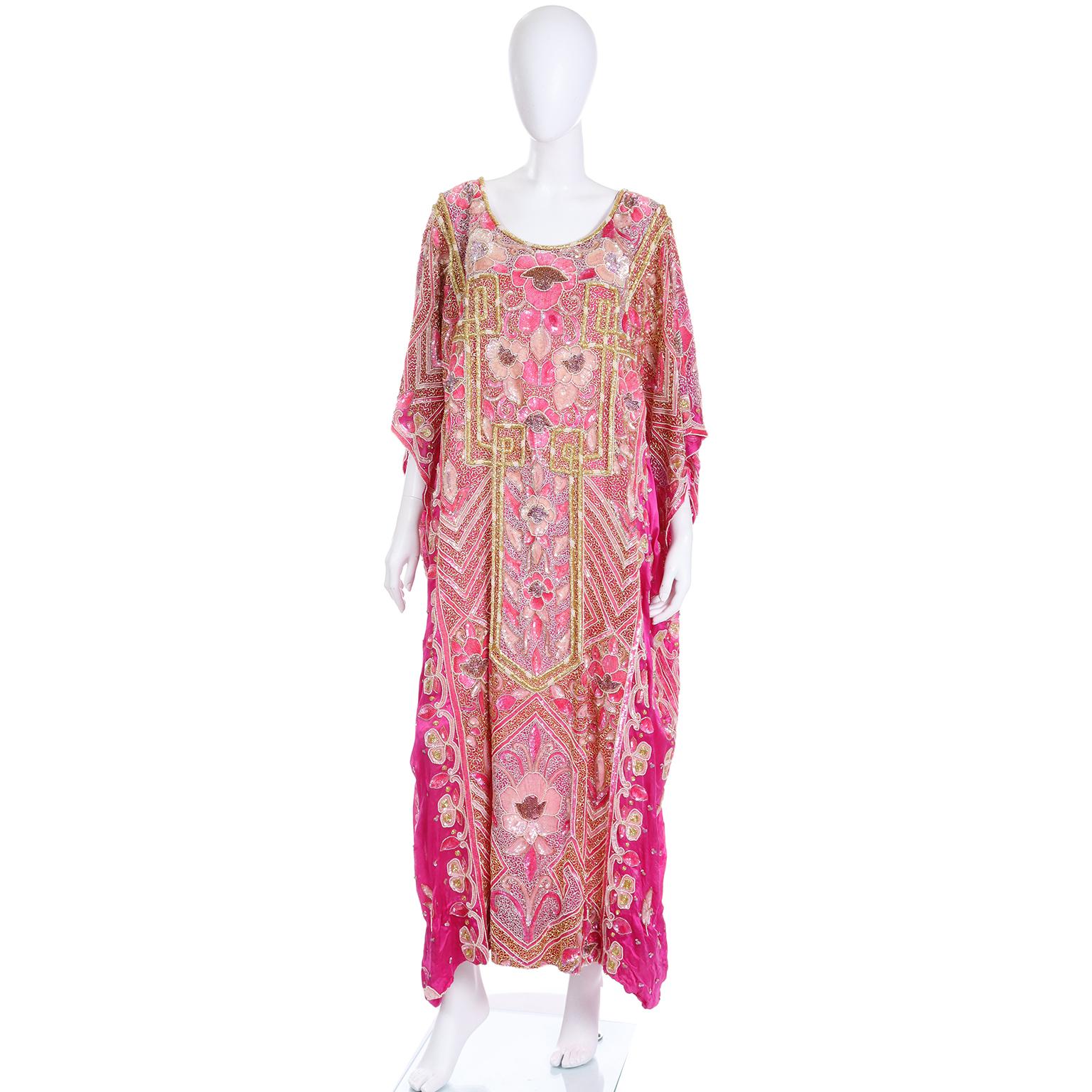 This is a gorgeous vintage caftan that could easily be worn as an evening gown. The base fabric is a vibrant hot pink and the dress is covered in beads and sequins! There are beautiful rows of thick, raised gold beads that add dimension to the