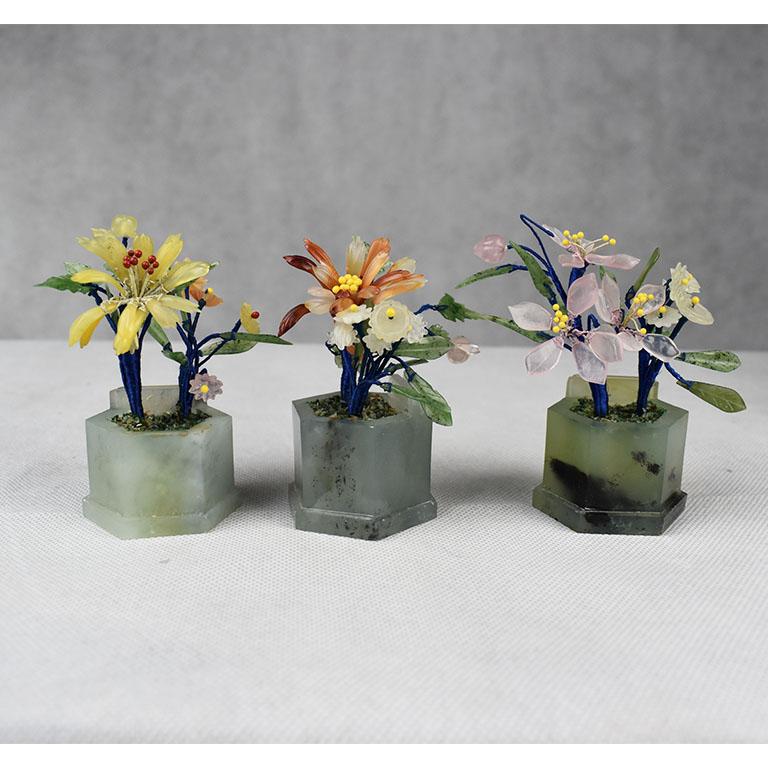 An incredible set of place card holders from Hong Kong. Each piece has a jade green color octagonal base. Flowers on green wire stems pop up through the top, giving the illusion of flowers growing from a pot. At the back of each piece, a small