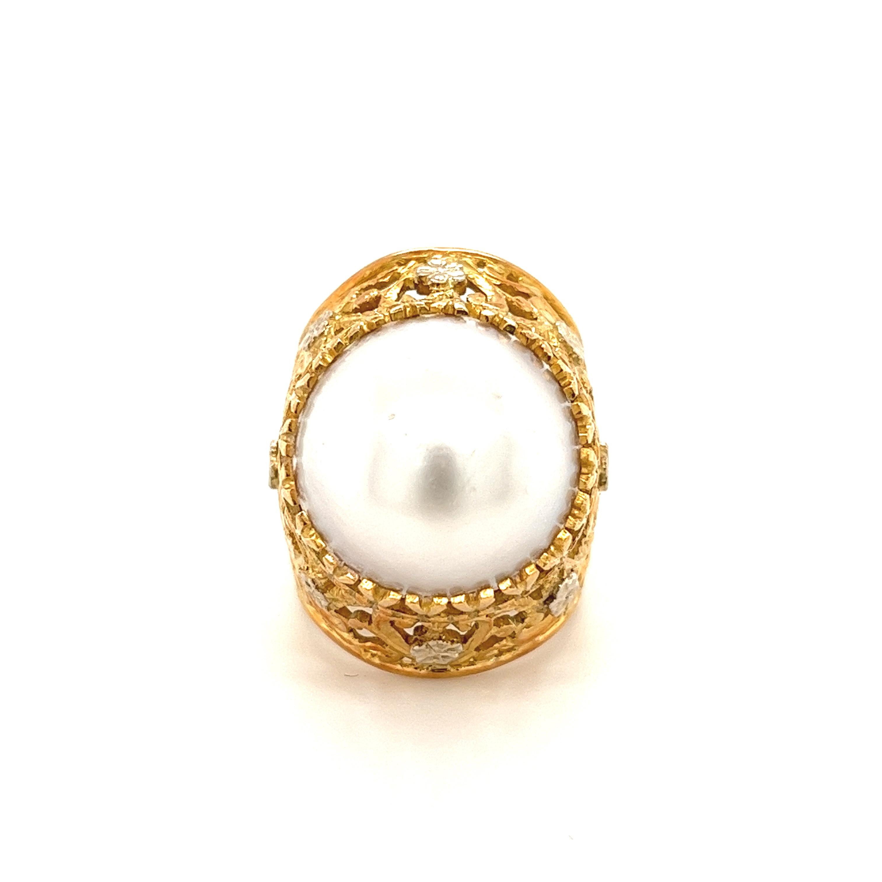 Gorgeous art nouveau style pinky ring featuring an 18k yellow gold band with an ornately carved design and a 15.3mm white freshwater pearl center stone. An expertly hand-crafted ring with practical features that make it ideal for everyday wear. The