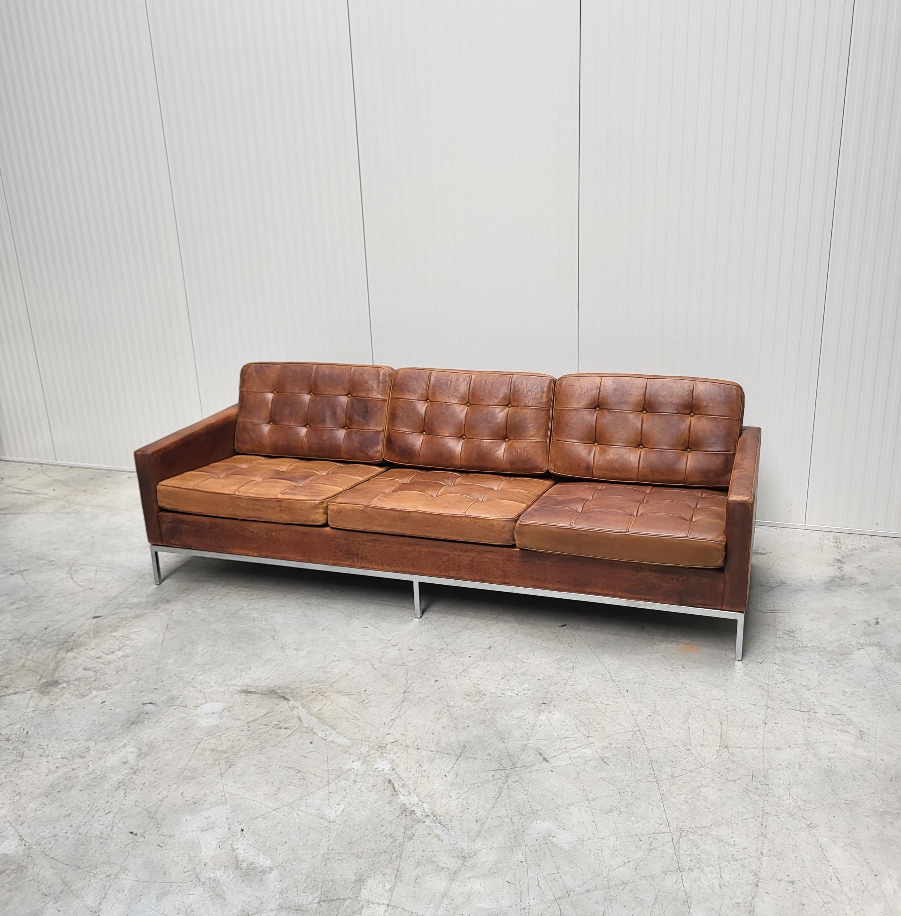 Ce canapé iconique et intemporel a été conçu en 1954 par Florence Knoll et produit par Knoll dans les années 1970. 

Le canapé est recouvert d'un cuir Mid Brown d'une patine magnifique. 
Dans l'ensemble, il est dans un bel état d'origine avec