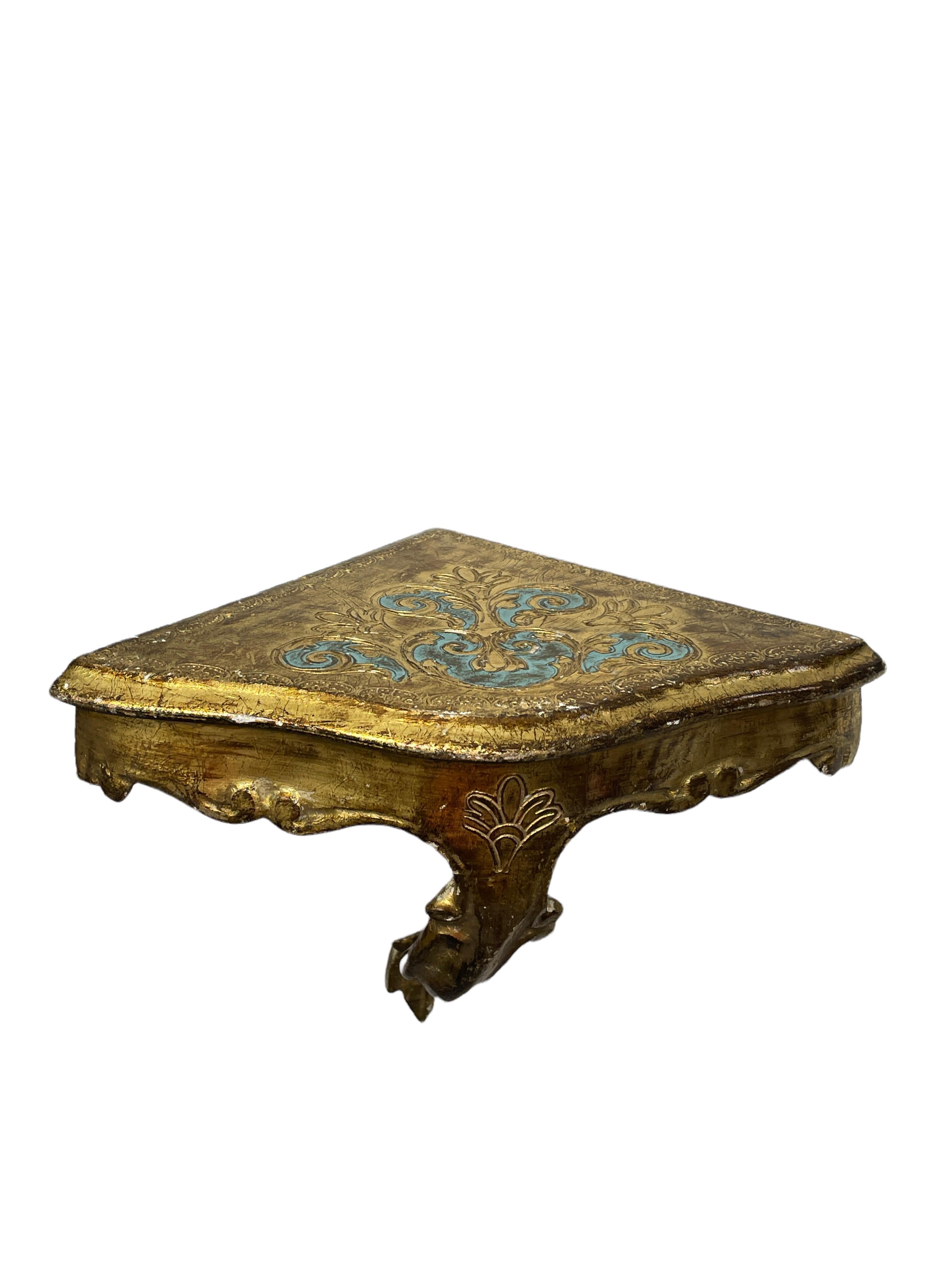 Offered is an absolutely stunning, 1960s Italian giltwood wall corner shelf or wall console. Minor patina and paint lost gives this piece a classy statement. Made of hand carved wood and gold plated. A nice shelf to present a statuette or a