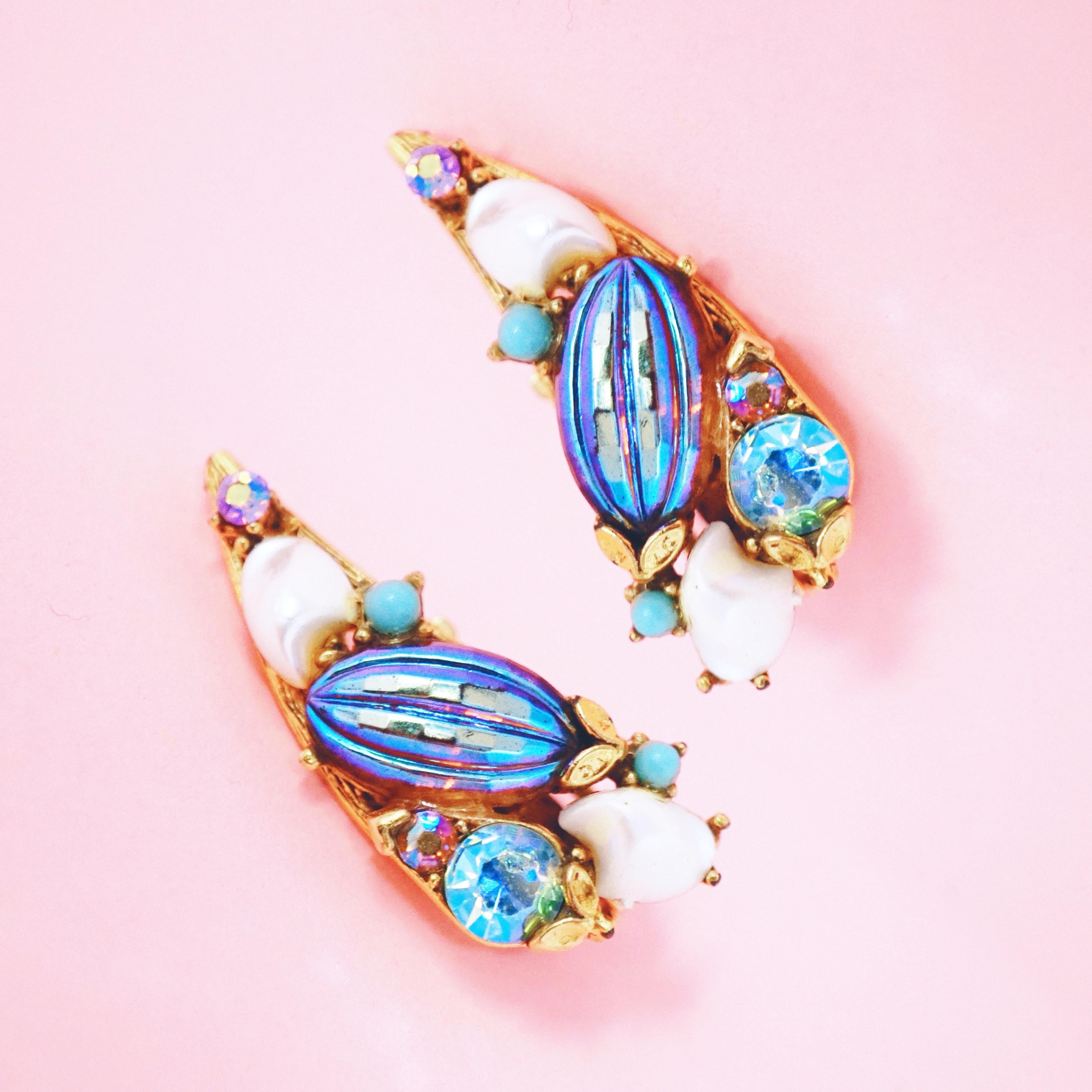 These rare gold plated crawler clip-on earrings by Florenza, circa 1970, are an absolutely stunning statement piece. The rich gilding and unique medley of Aurora Borealis iridescent rhinestones and glass beads with faux pearl and turquoise cabochons